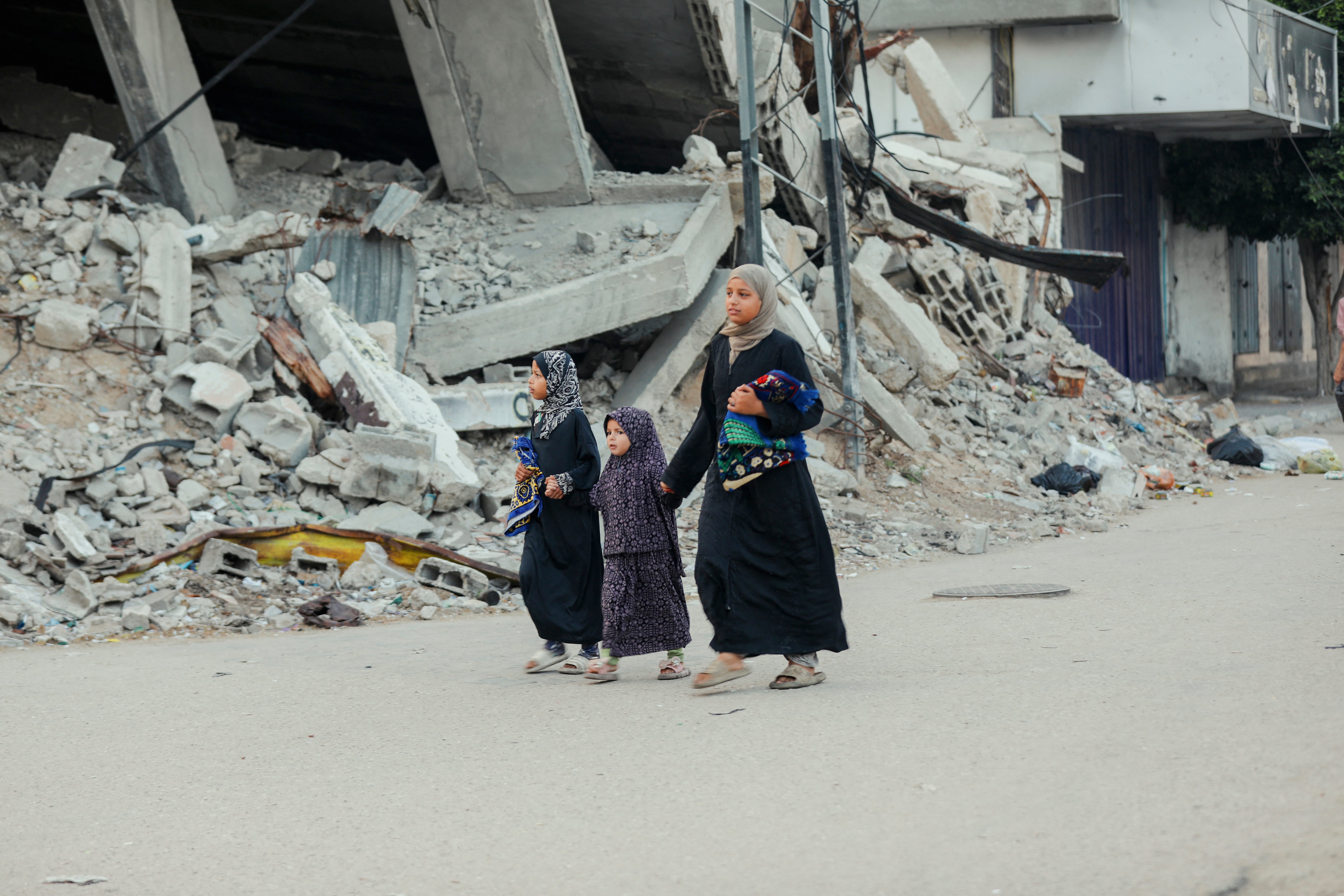 Palestinians gather to perform Eid prayers amid the rubble of destroyed buildings in Gaza