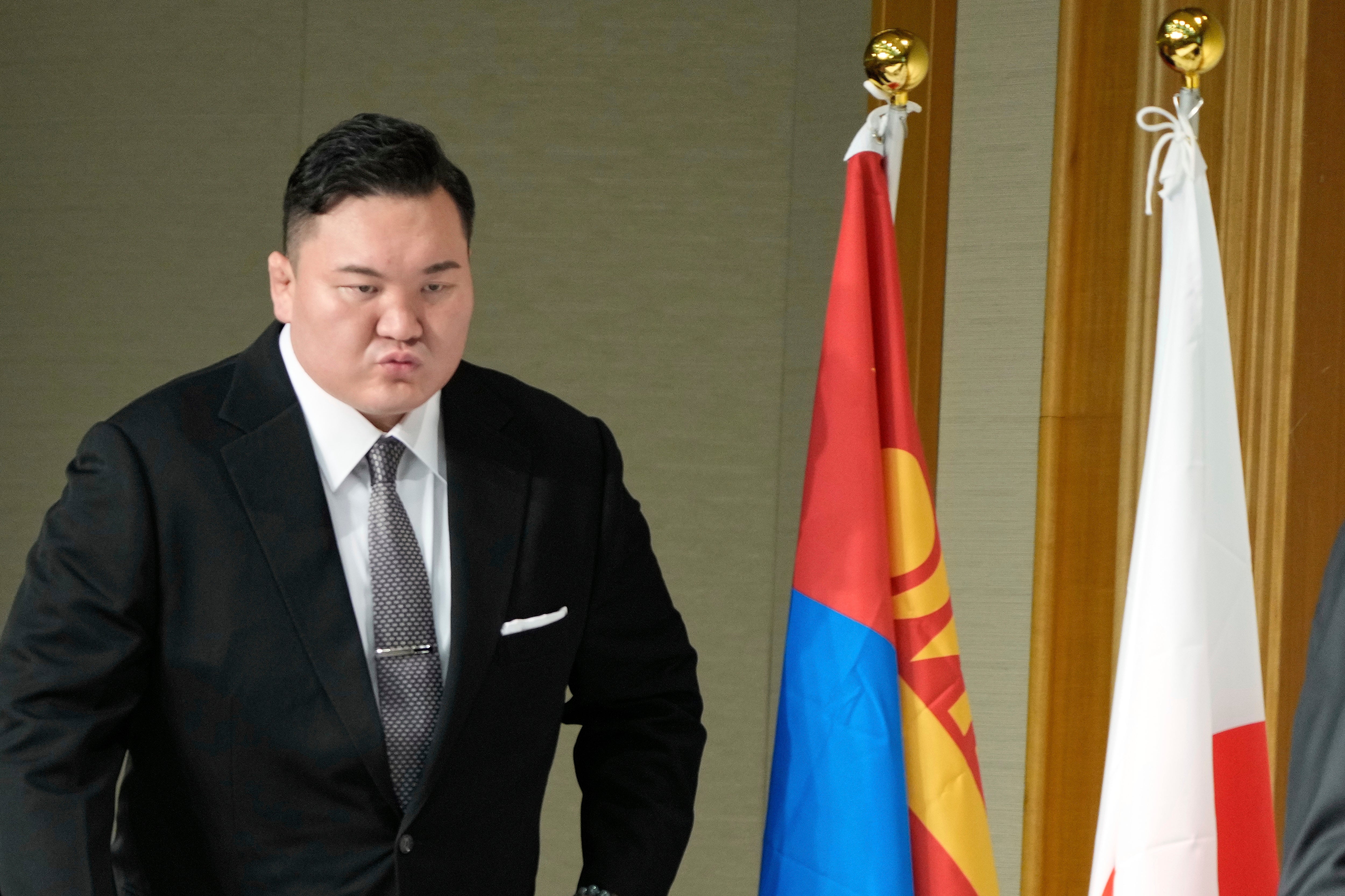 Hakuho Sho, a retired “yokozuna” or grand champion of sumo, Hakuho, walks to the venue for a press conference in Tokyo, Monday, June 9, 2025, to deliver a farewell message following the reported acceptance of his resignation. (AP Photo/Eugene Hoshiko)