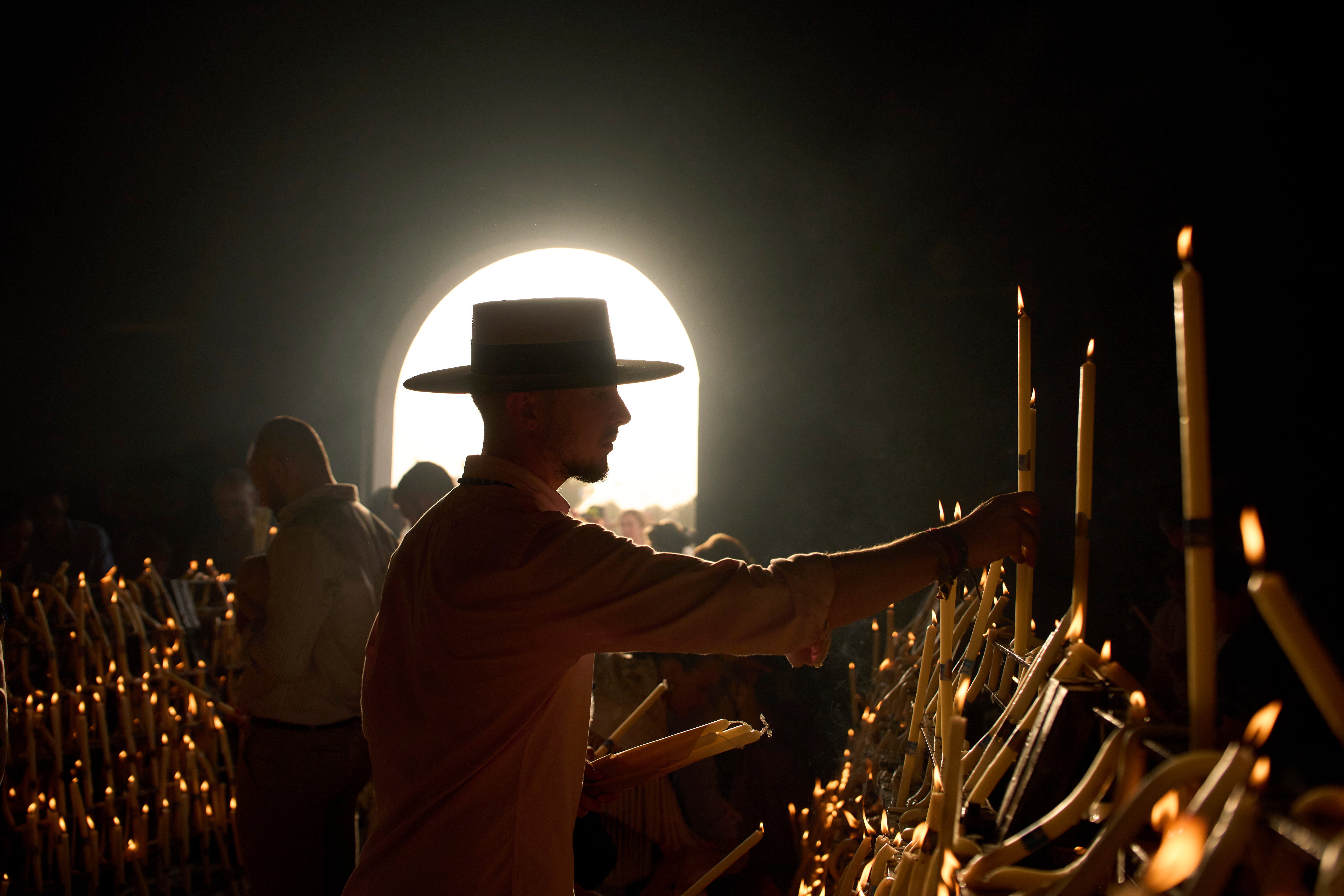 Pilgrims light candles at the shrine of El Rocio.