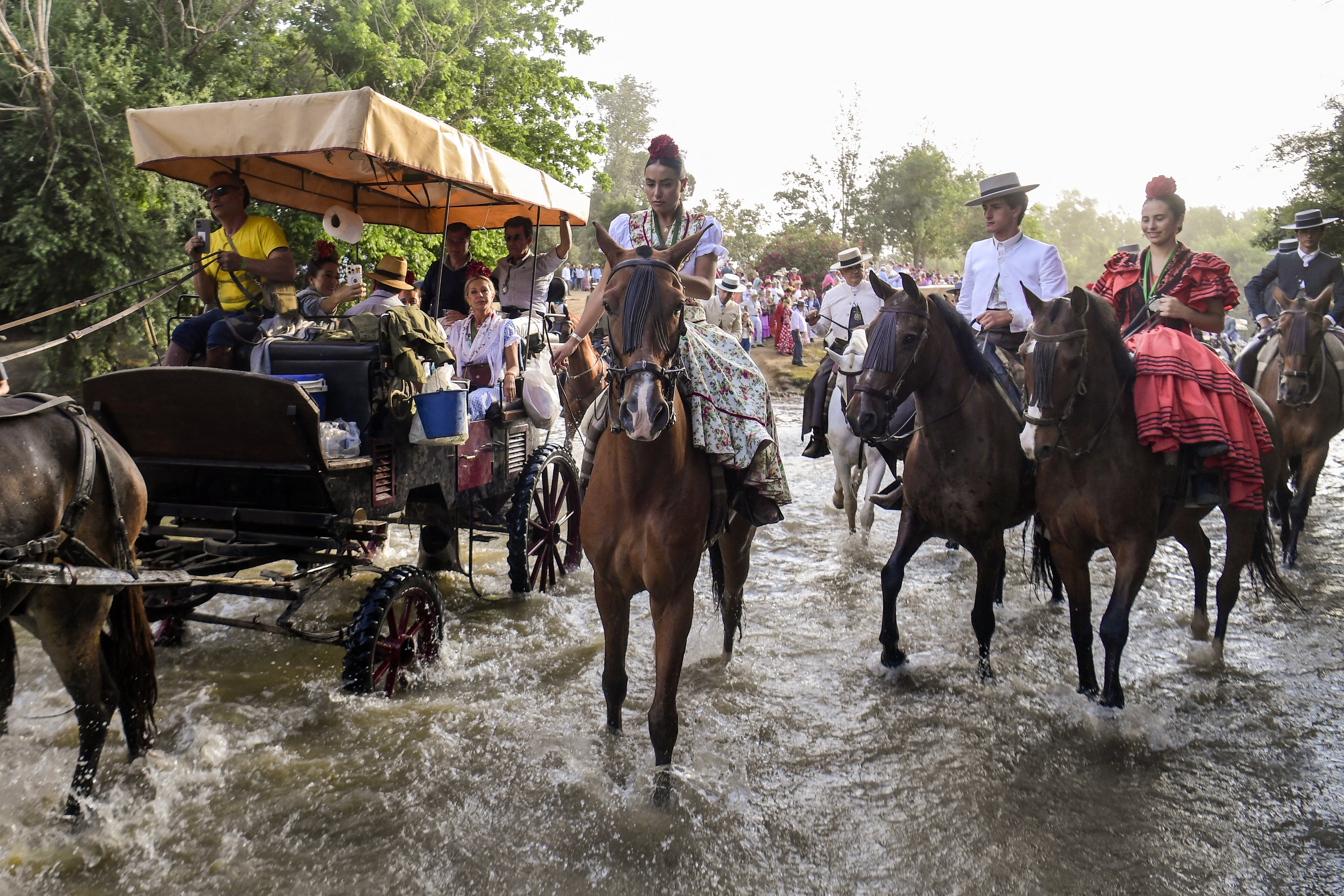 Pilgrims of the Triana brotherhood ride horses across the Quema river in Villamanrique, during a pilgrimage on the way to the village of El Rocio.