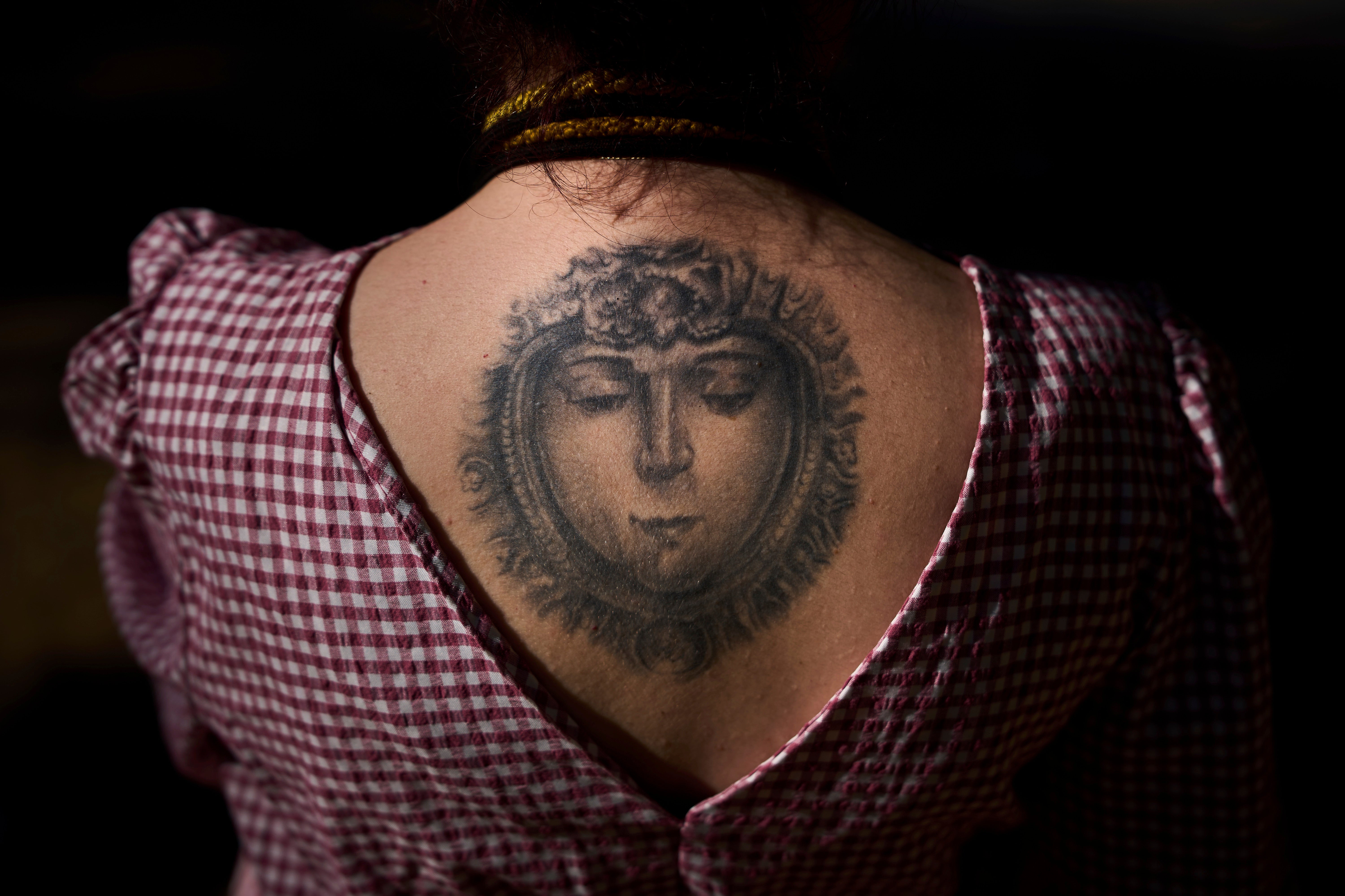 An image of the Virgen del Rocio is photographed tattooed on the back of Paloma Maria, a pilgrim from Cordoba.