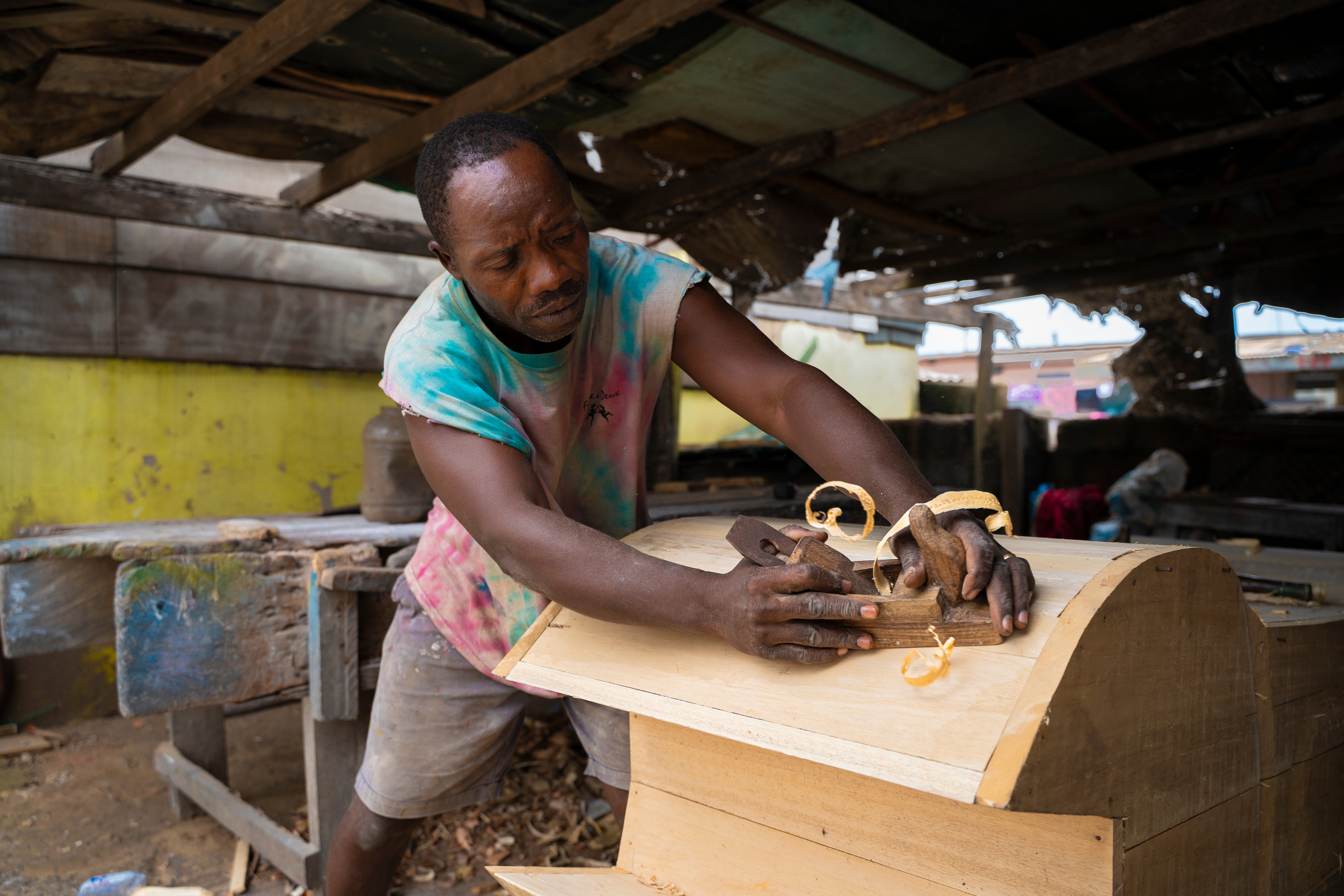 The craftsman’s designs have included a beer bottle- and an octopus-shaped coffin