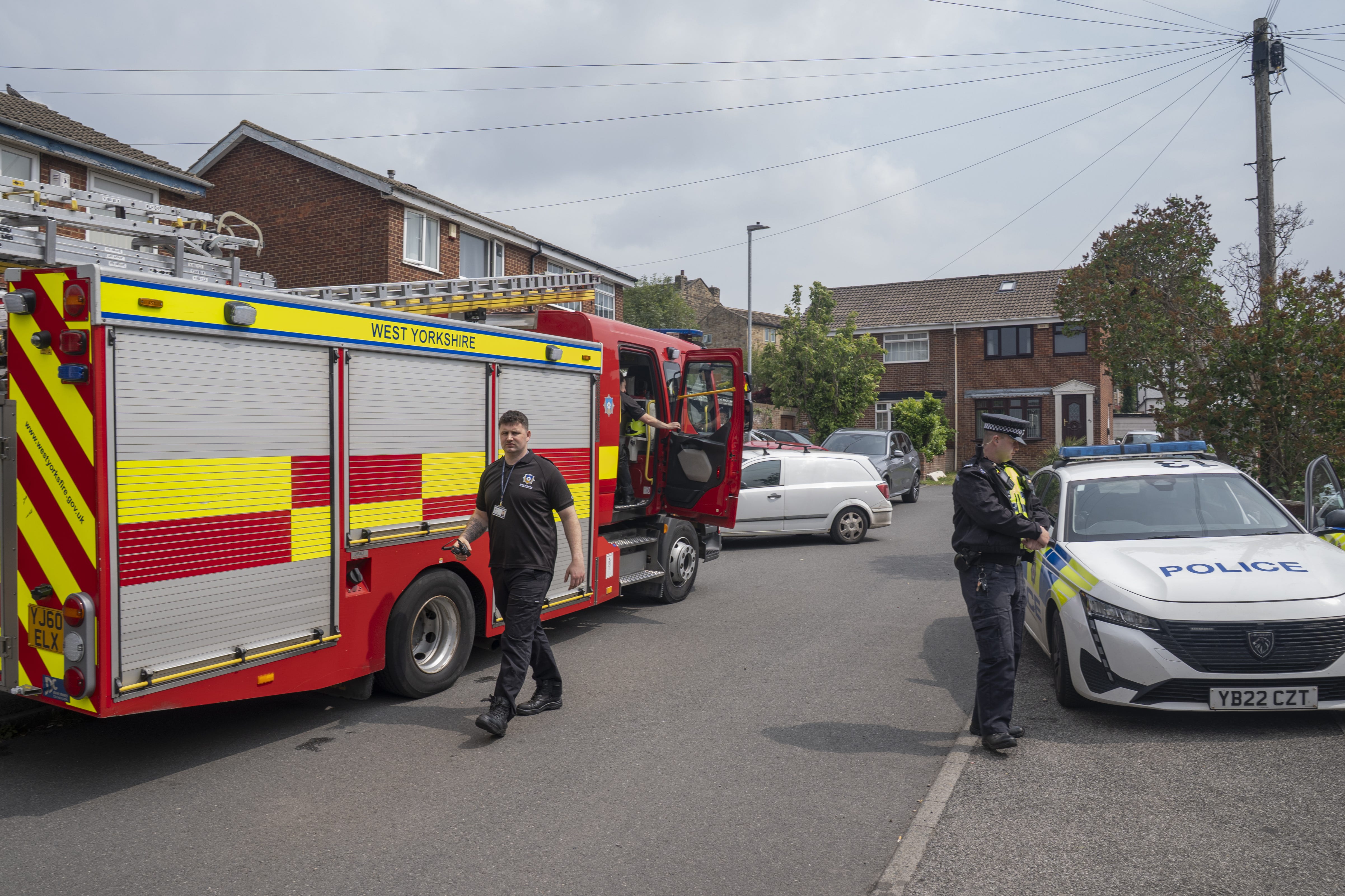 Emergency services at the scene on Russell Close in Heckmondwike, West Yorkshire, where a man and a nine-year-old girl died in a house fire (Danny Lawson/PA)