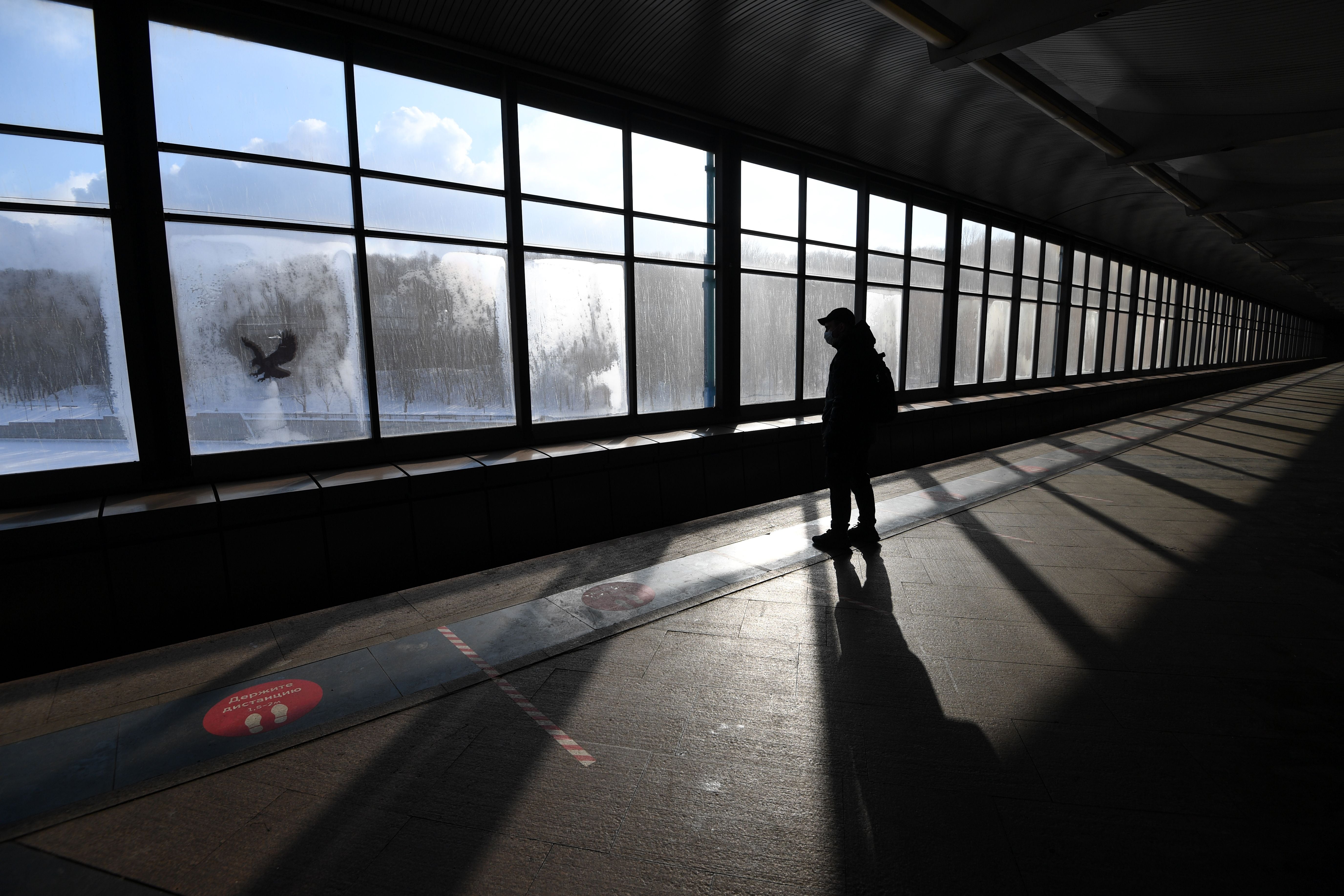 A man wearing a face mask waits for a train at a metro station in Moscow on February 18, 2021.