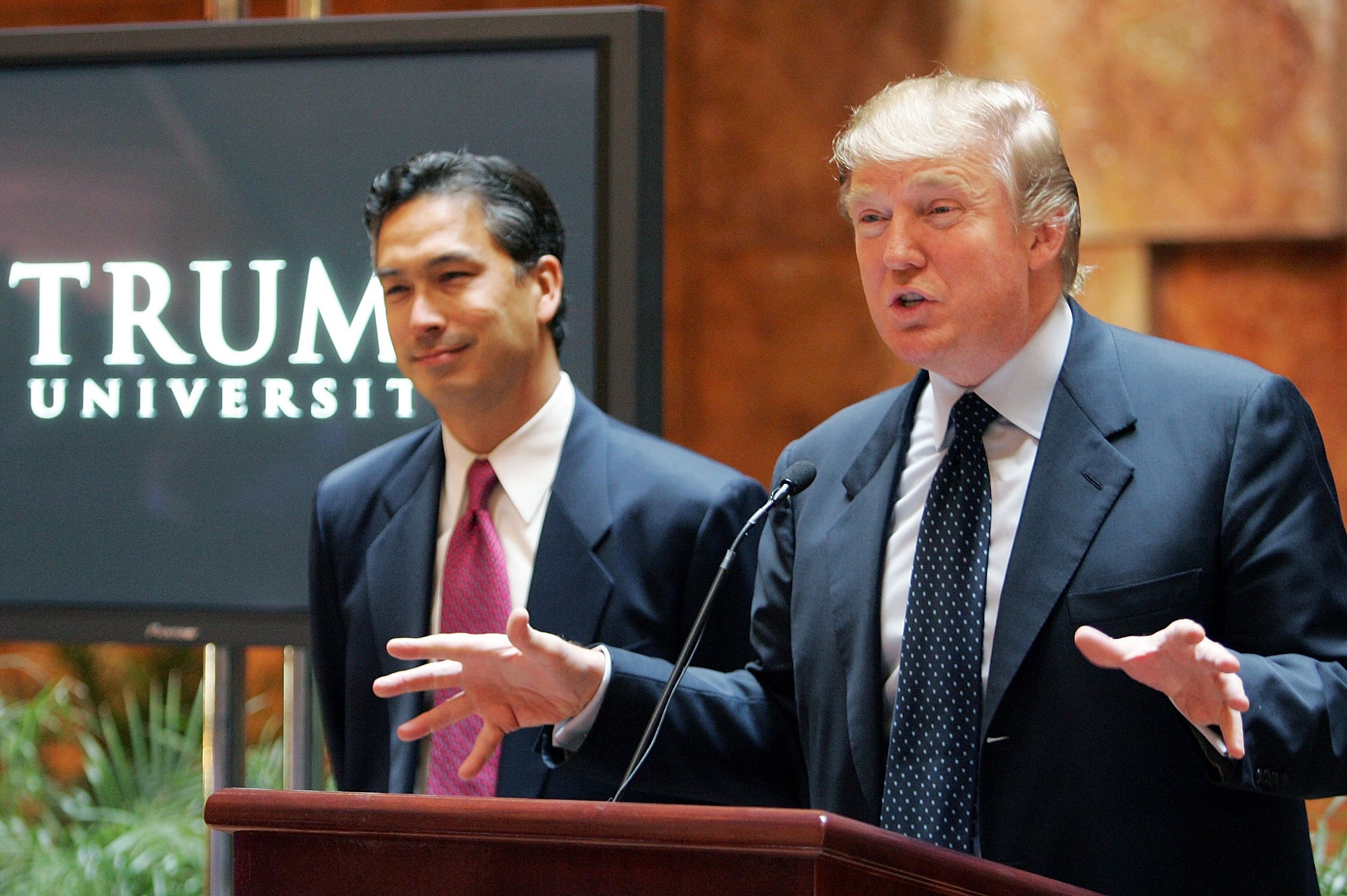 Donald Trump announces Trump University in New York City in May 2005, alongside university president Michael Sexton (left)