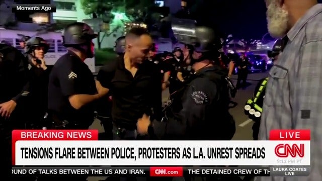Los Angeles police officers let CNN reporter Jason Carroll go after detaining and removing him from a protest scene.