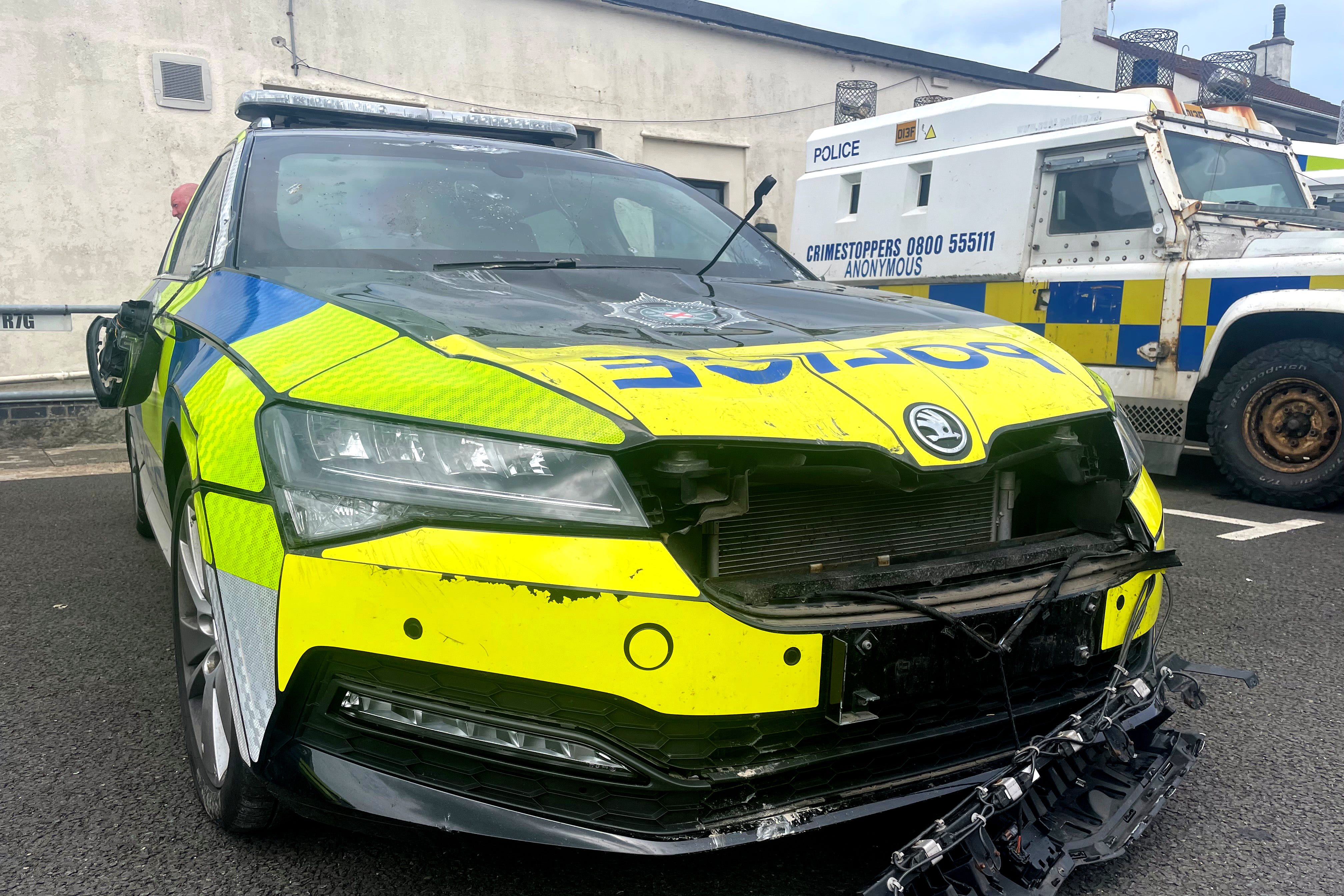 A damaged police car outside Ballymena PSNI station, following a protest over an alleged sexual assault in the Co Antrim town (Jonathan McCambridge/PA)