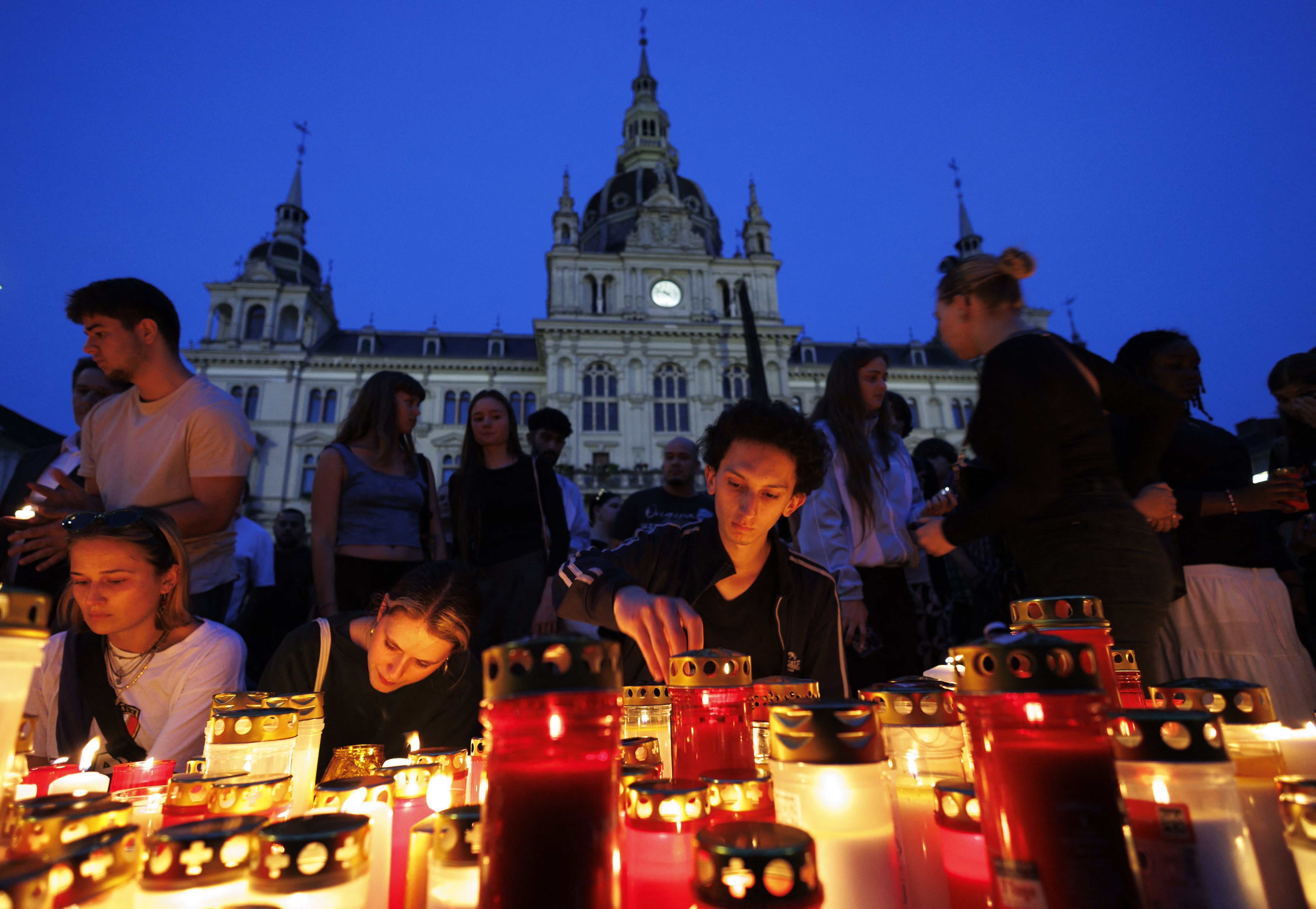 Residents hold vigil for victims on Tuesday evening