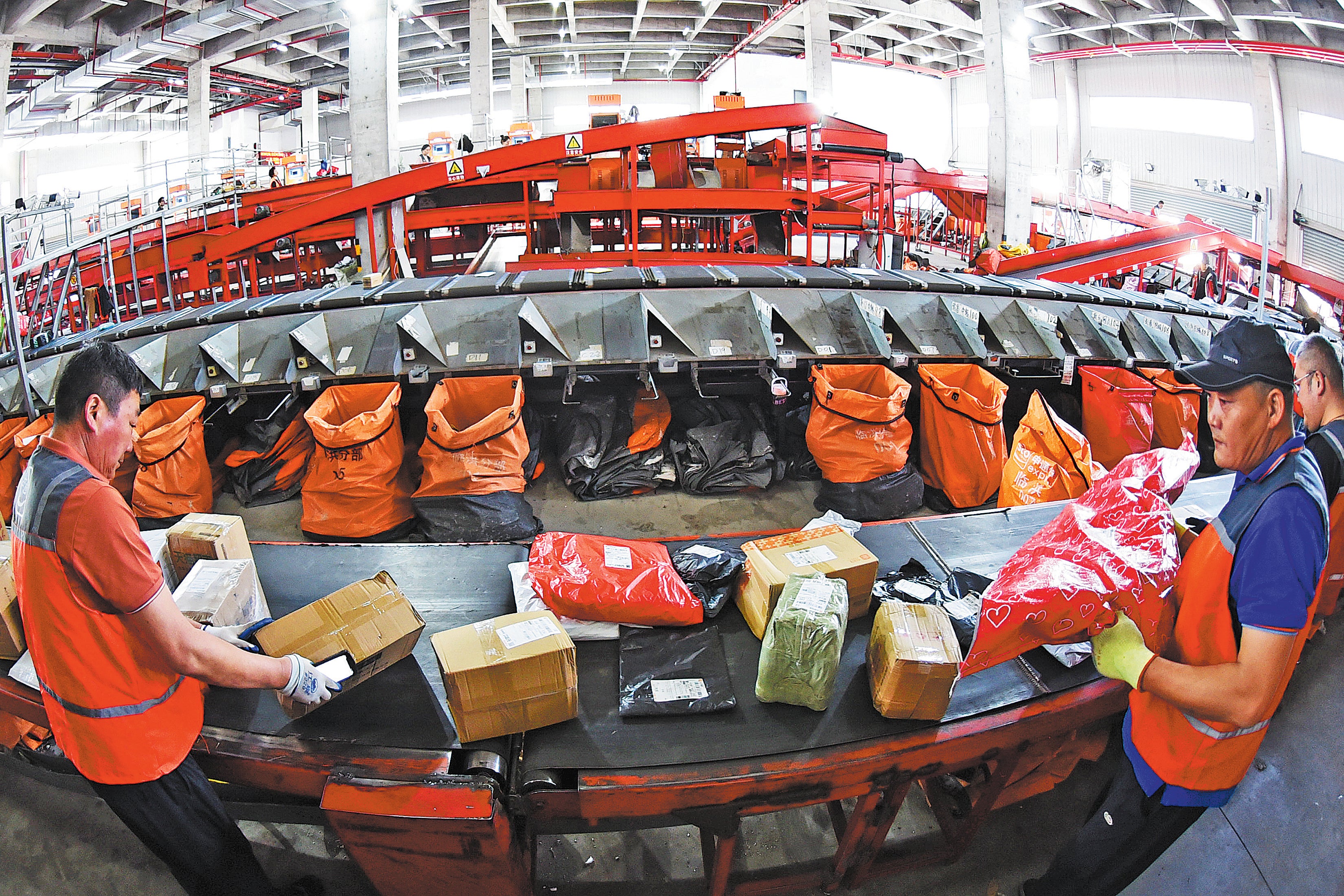 Staff members sort packages at a delivery distribution centre in Lianyungang, Jiangsu province