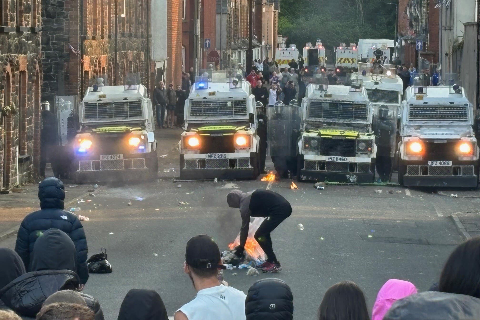 Riot police vans at Clonavon Terrace, Ballymena on Tuesday night (Niall Carson/PA)