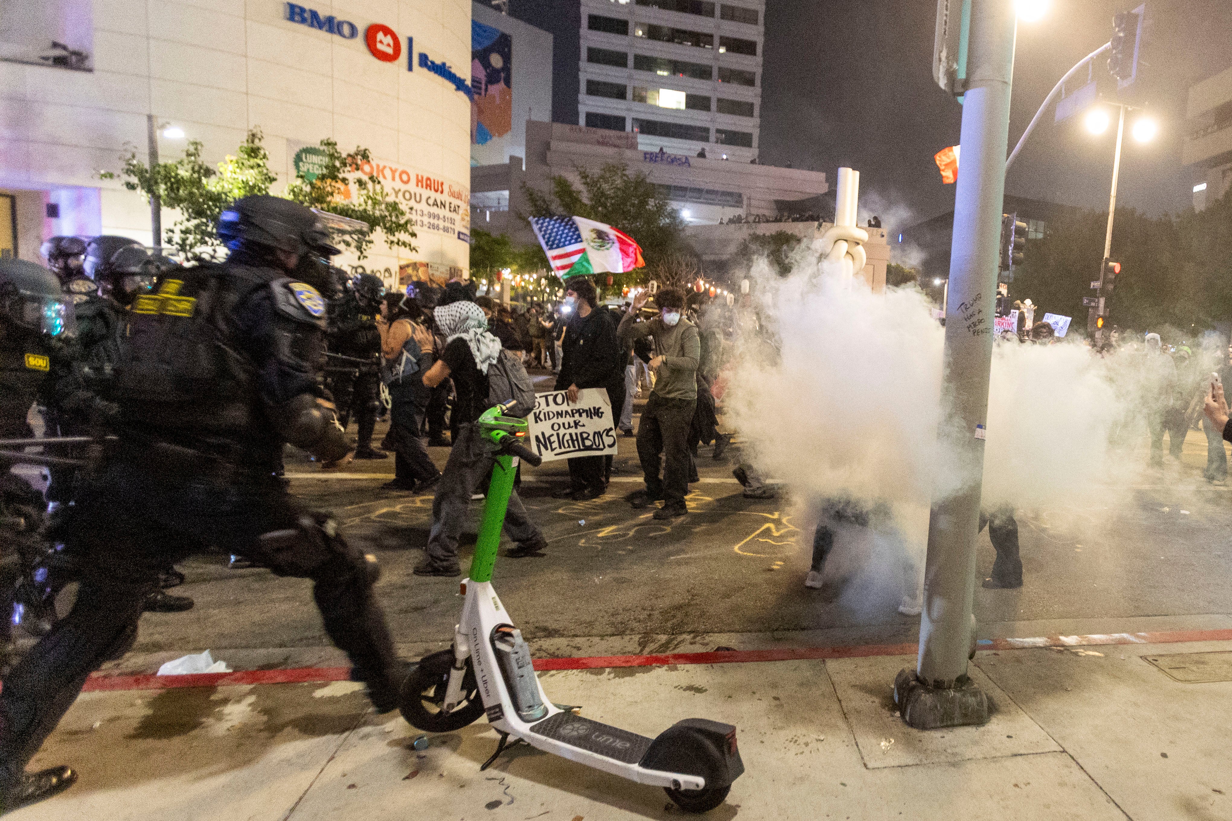 According to the Los Angeles Police Department, at least 50 people were arrested over the weekend. These included a man accused of ramming a motorbike into a line of officers and another who threw a Molotov cocktail
