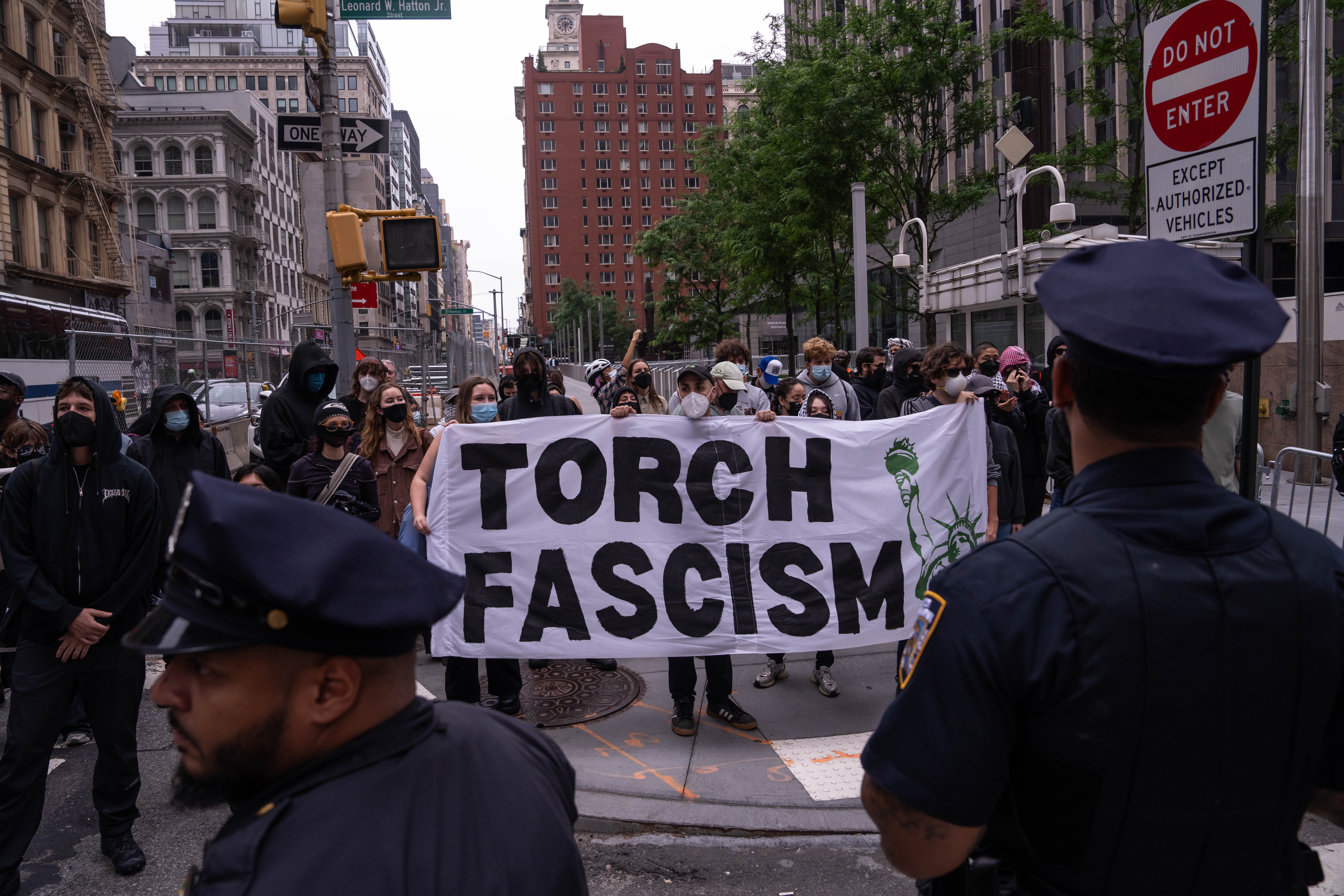 People protest against federal immigration raids outside of the Jacob K Javits Federal Building in New York City