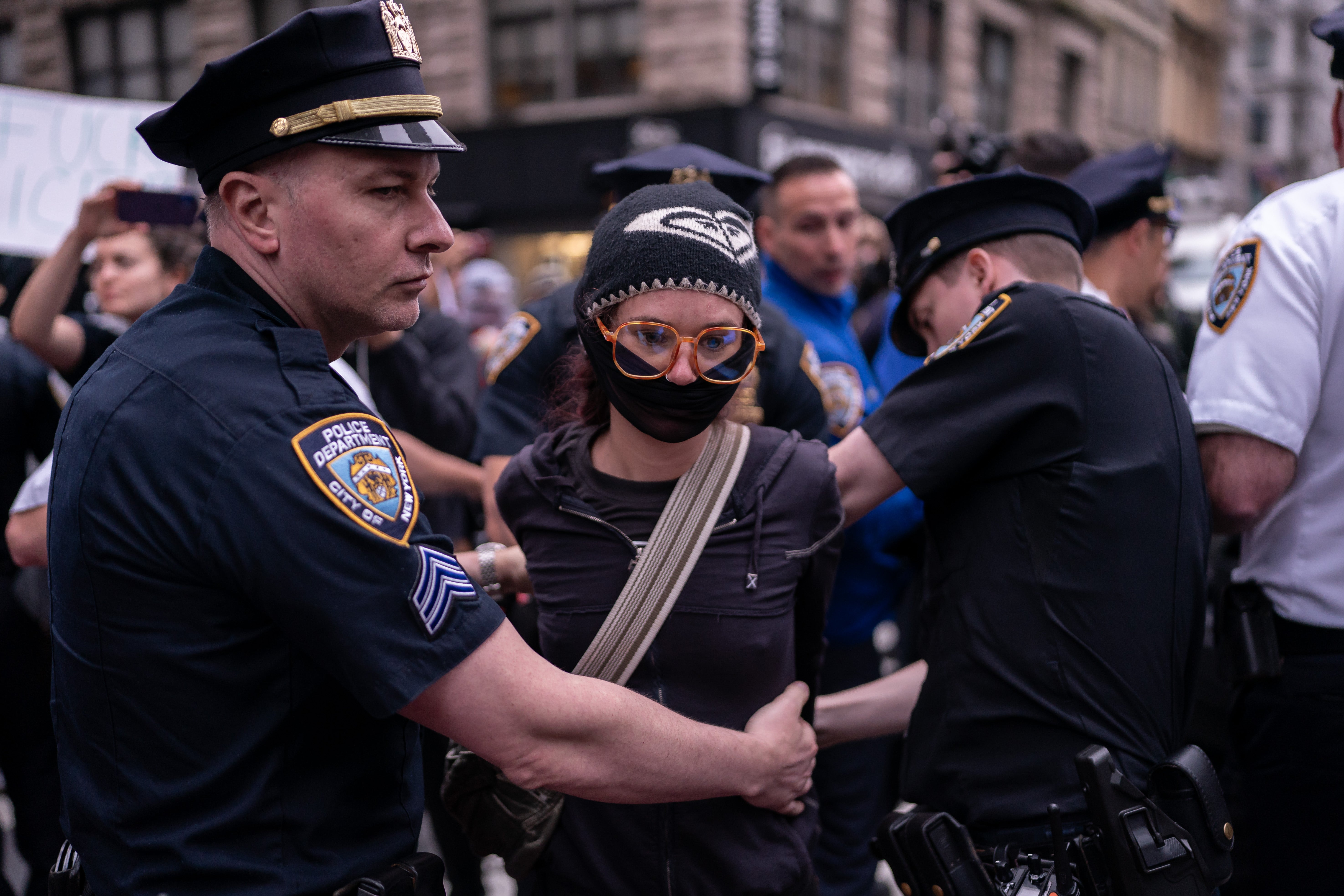 A person is detained by NYPD Strategic Response Group officers for blocking a law enforcement vehicle outside of the Jacob K Javits Federal Building in New York City