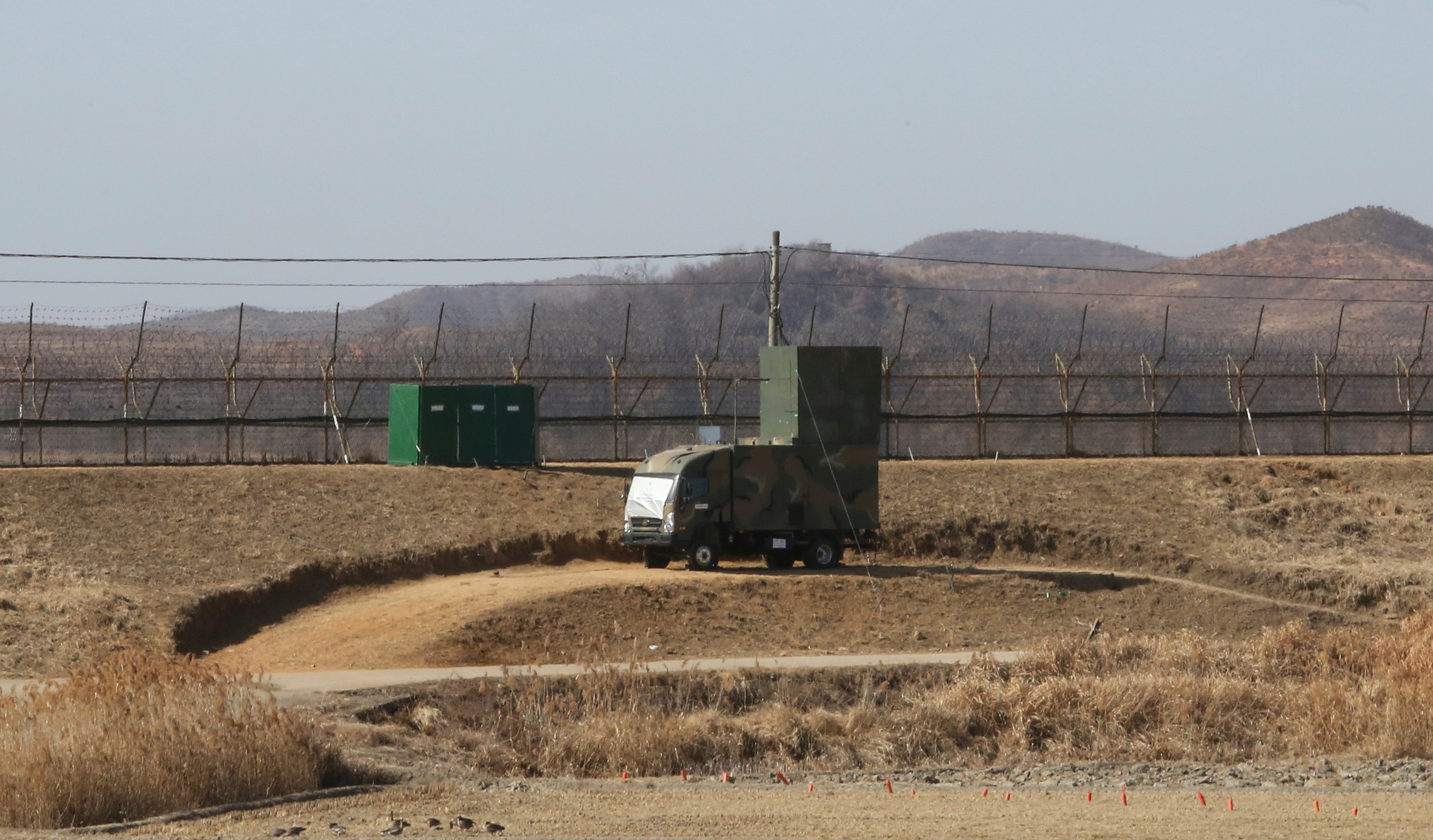 A South Korean military vehicle with loudspeakers is seen in front of the barbed-wire fence in Paju, near the border with North Korea