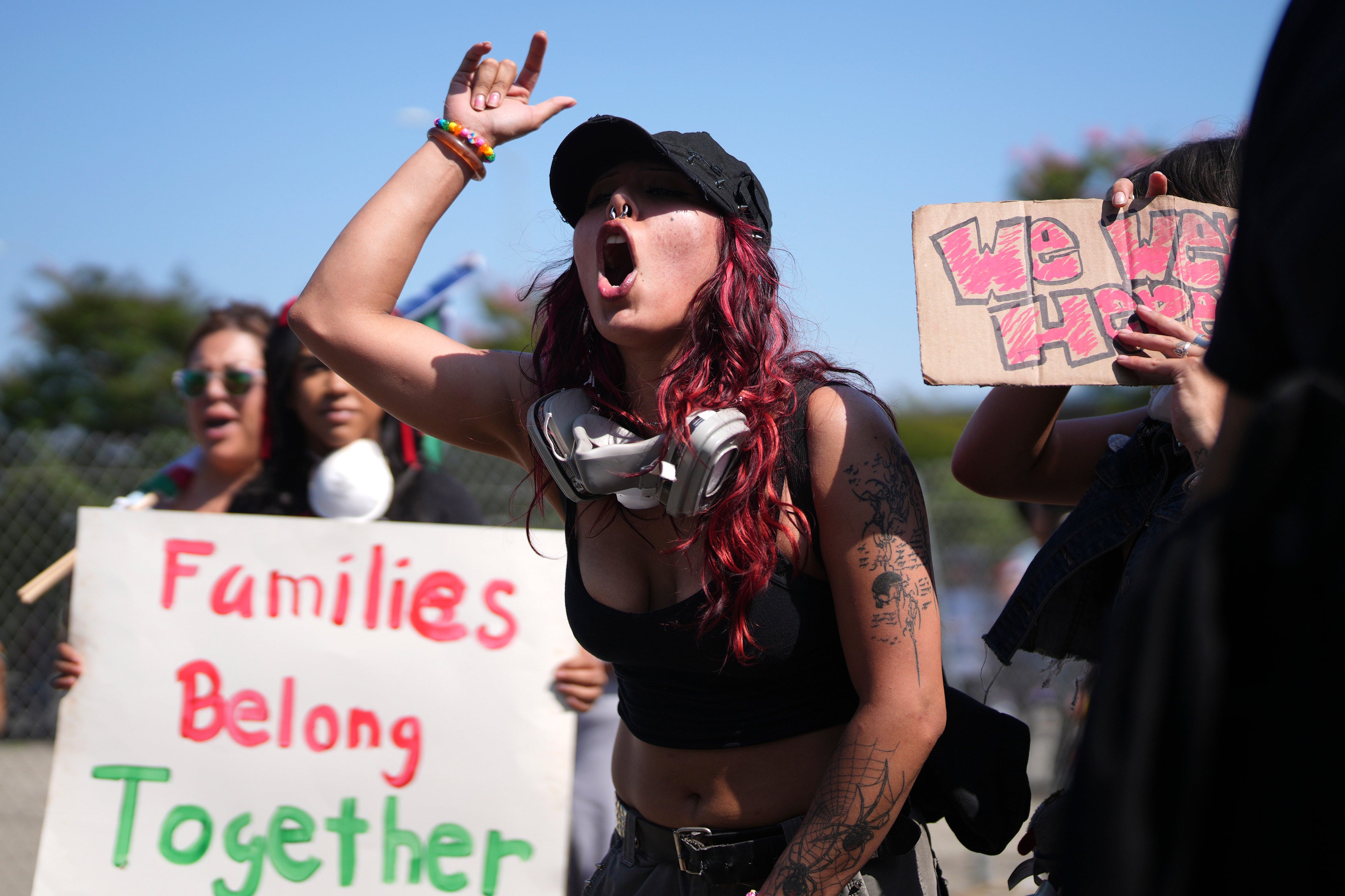 A protester yells at police and federal agents in an action to denounce the ICE, U.S. Immigration and Customs Enforcement, operations in the area Tuesday