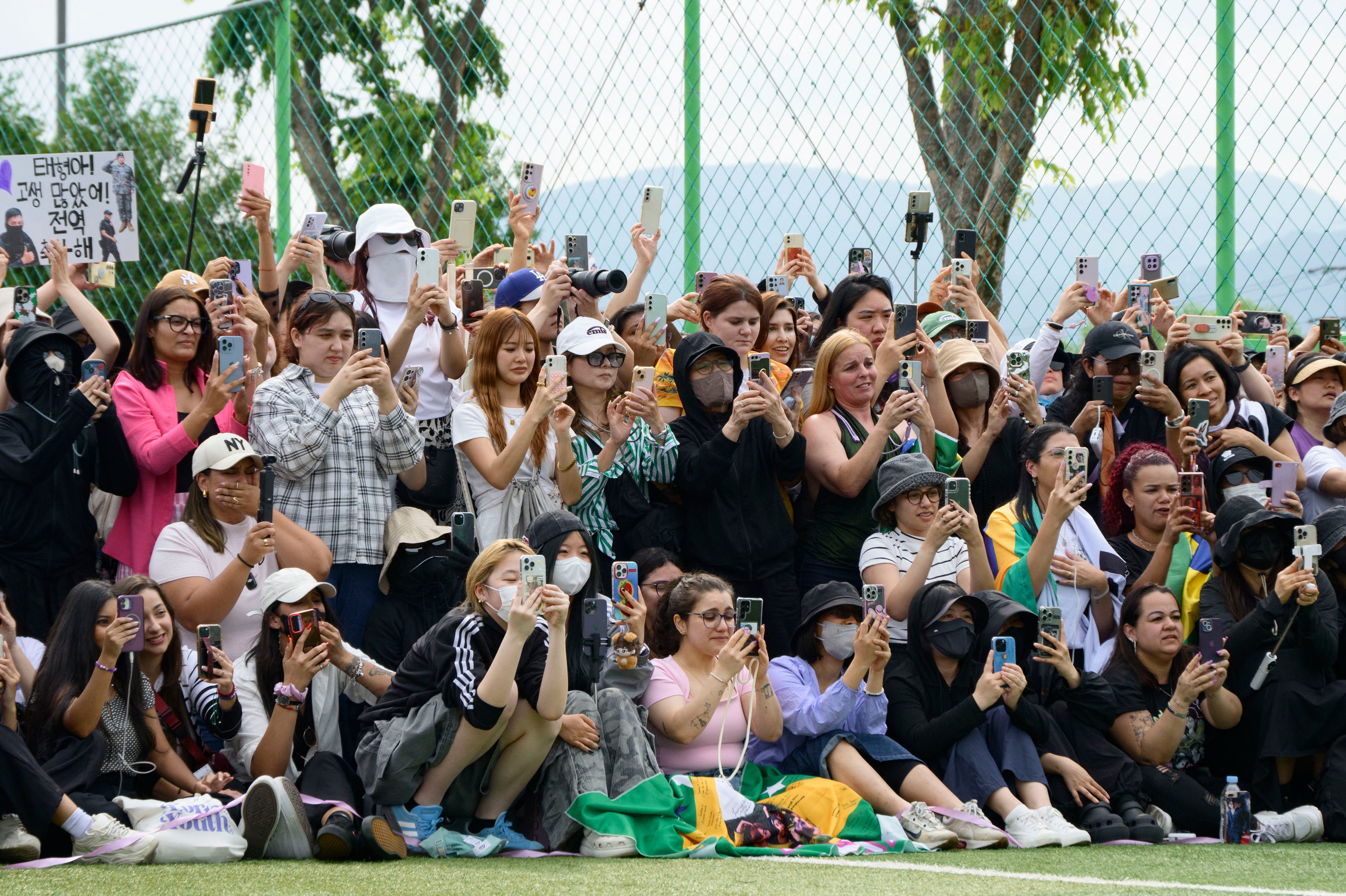 Fans of BTS members RM and V gather at an outdoor sporting facility in Chuncheon