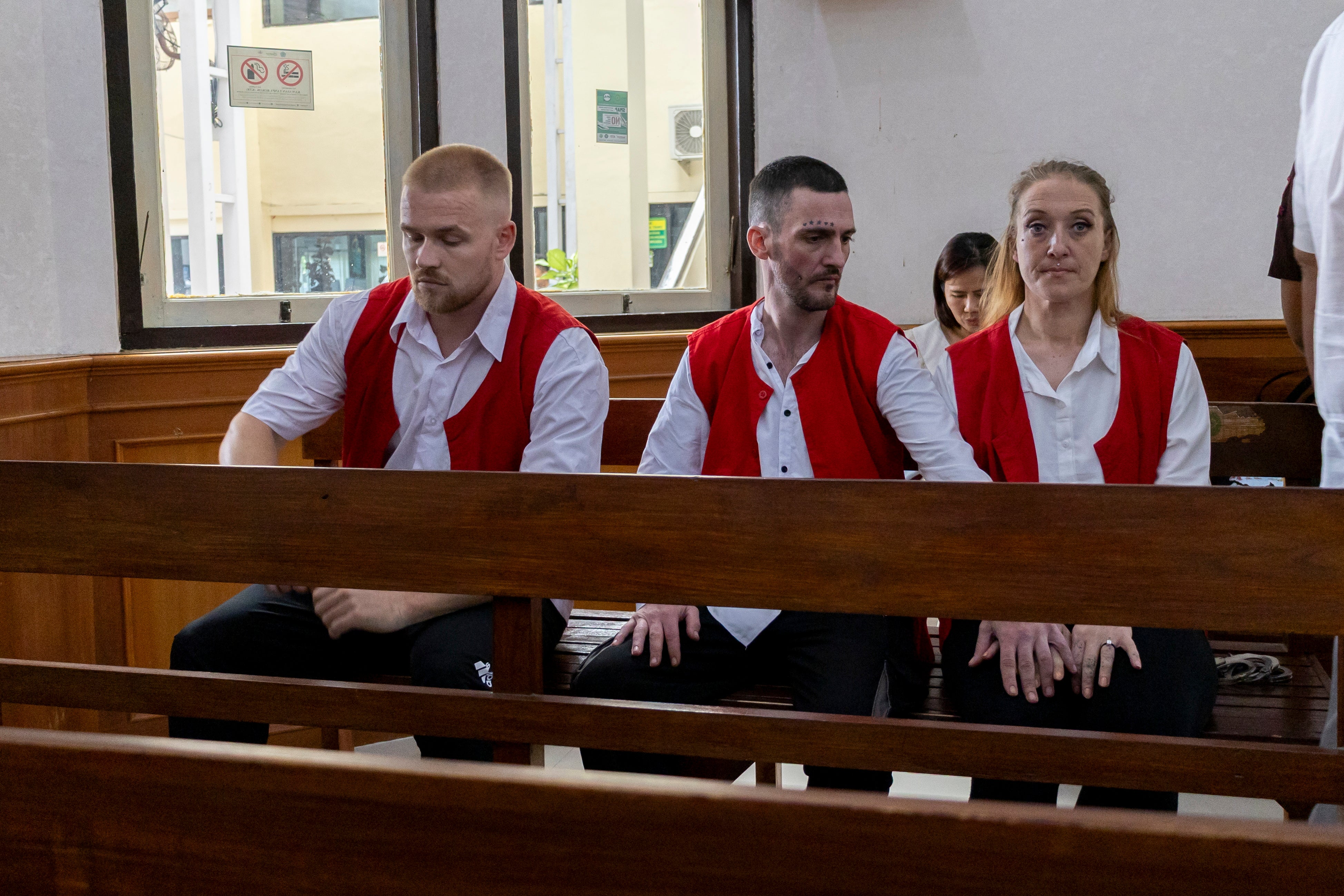 Phineas Float, left, Jonathan Collyer, centre, and Lisa Stocker of Britain inside a courtroom for their trial at the Denpasar District Court