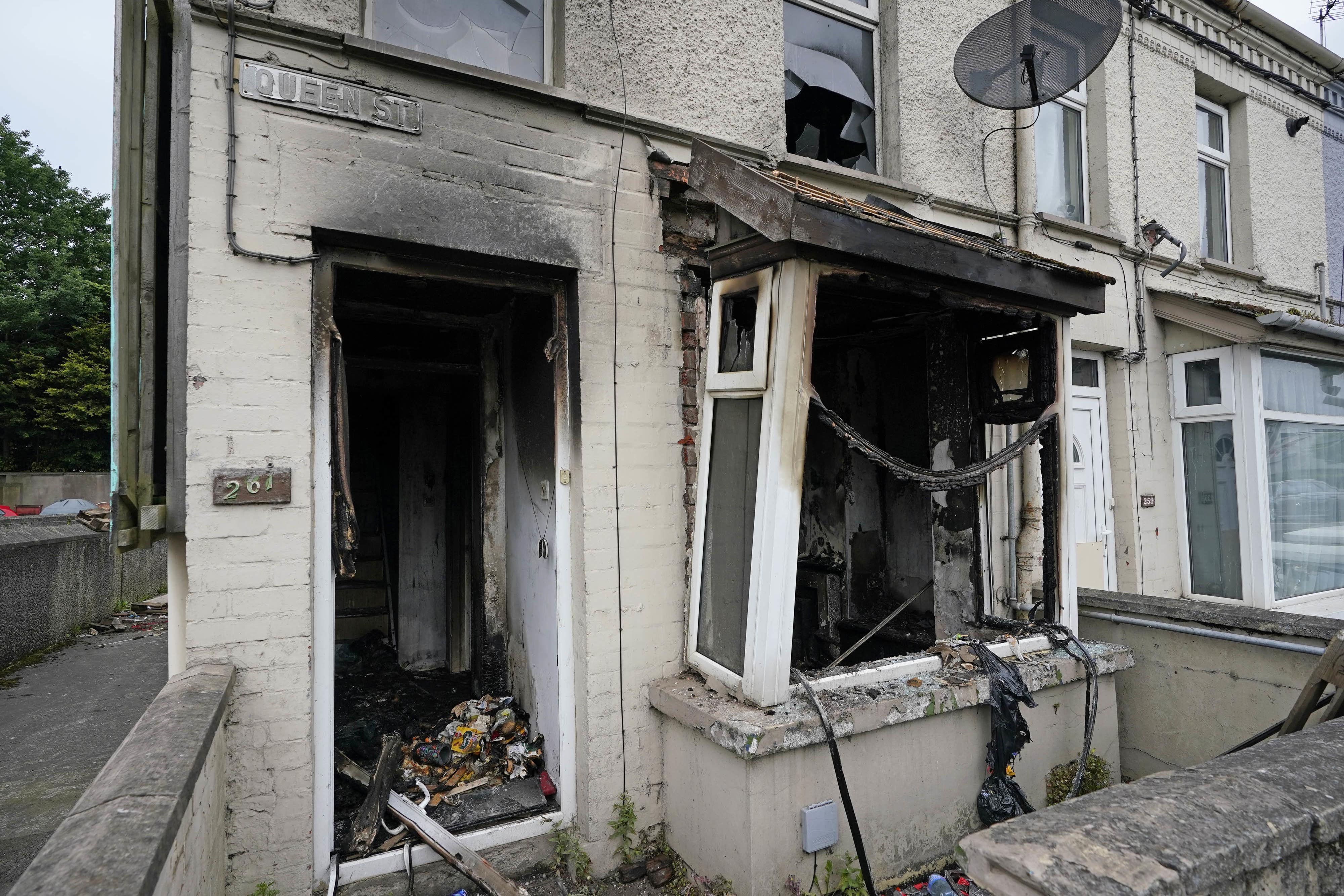 A burnt-out house on Queen Street after a second night of violence in Ballymena (Niall Carson/PA)