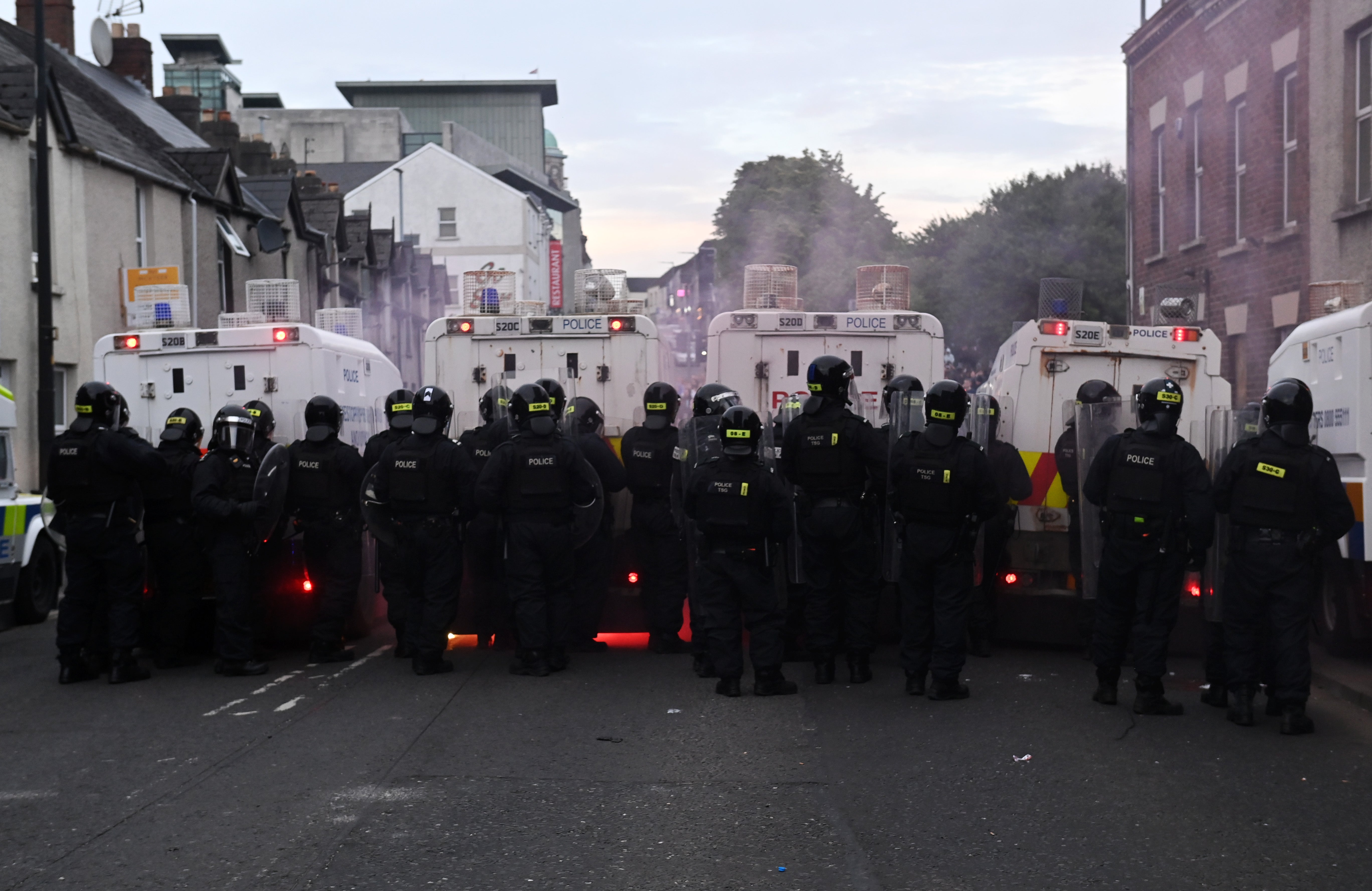 Riot police with shields advanced on crowds to disperse them
