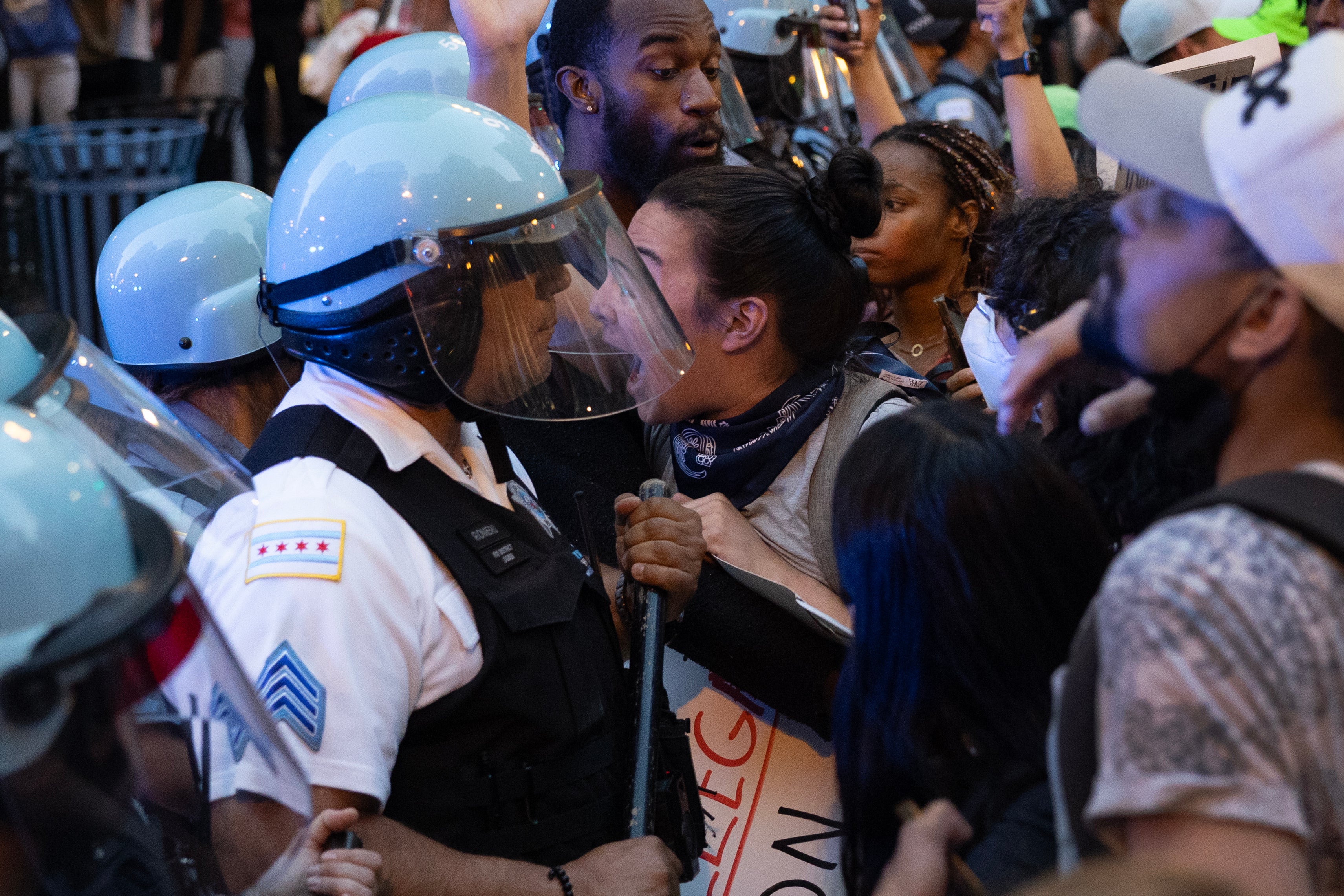 Police officers face off with immigrant rights protesters in the Loop on Tuesday in Chicago, Illinois