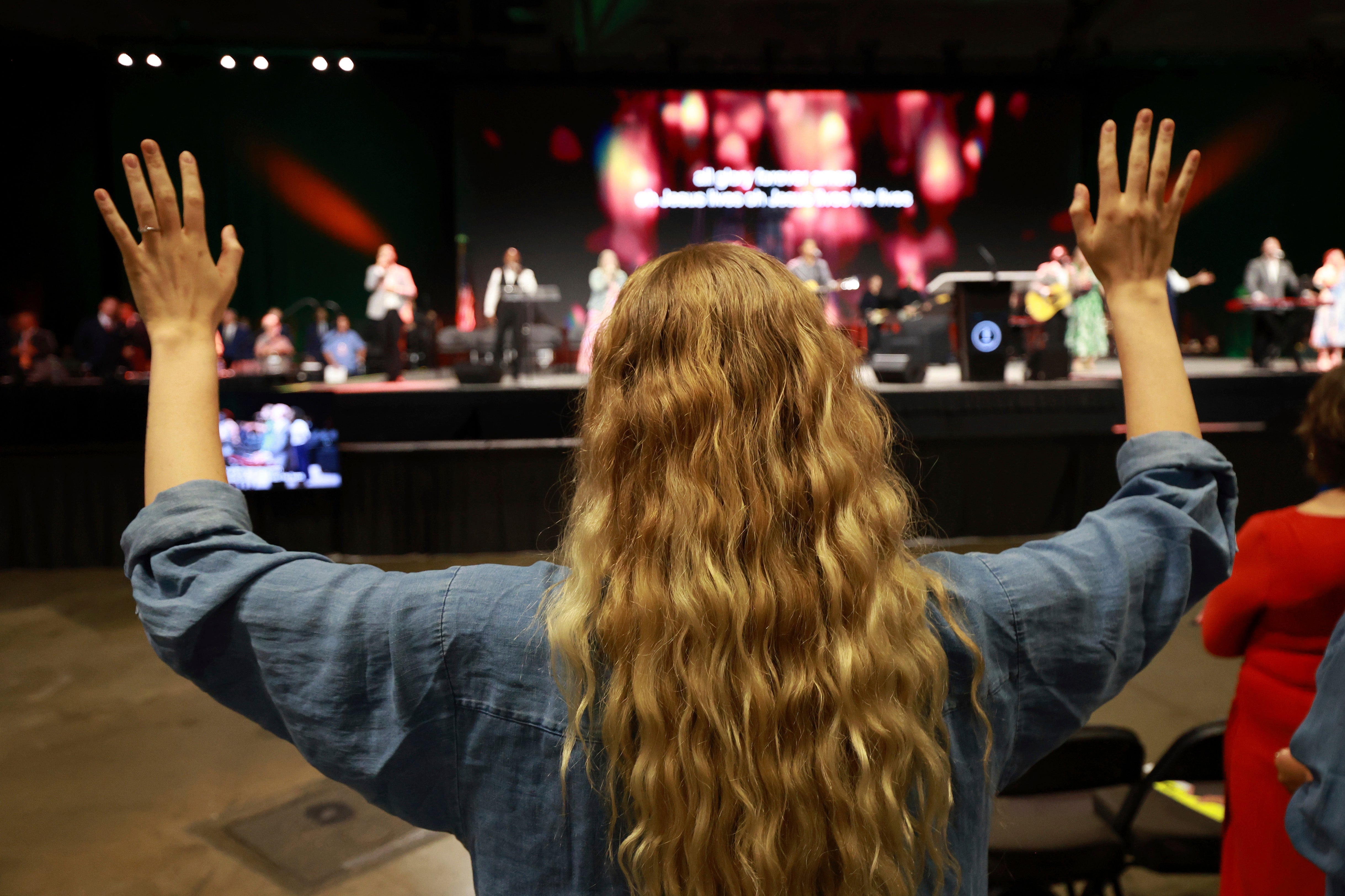 A messenger attending the Southern Baptist Convention participates in worship during the 2025 SBC Annual Meeting