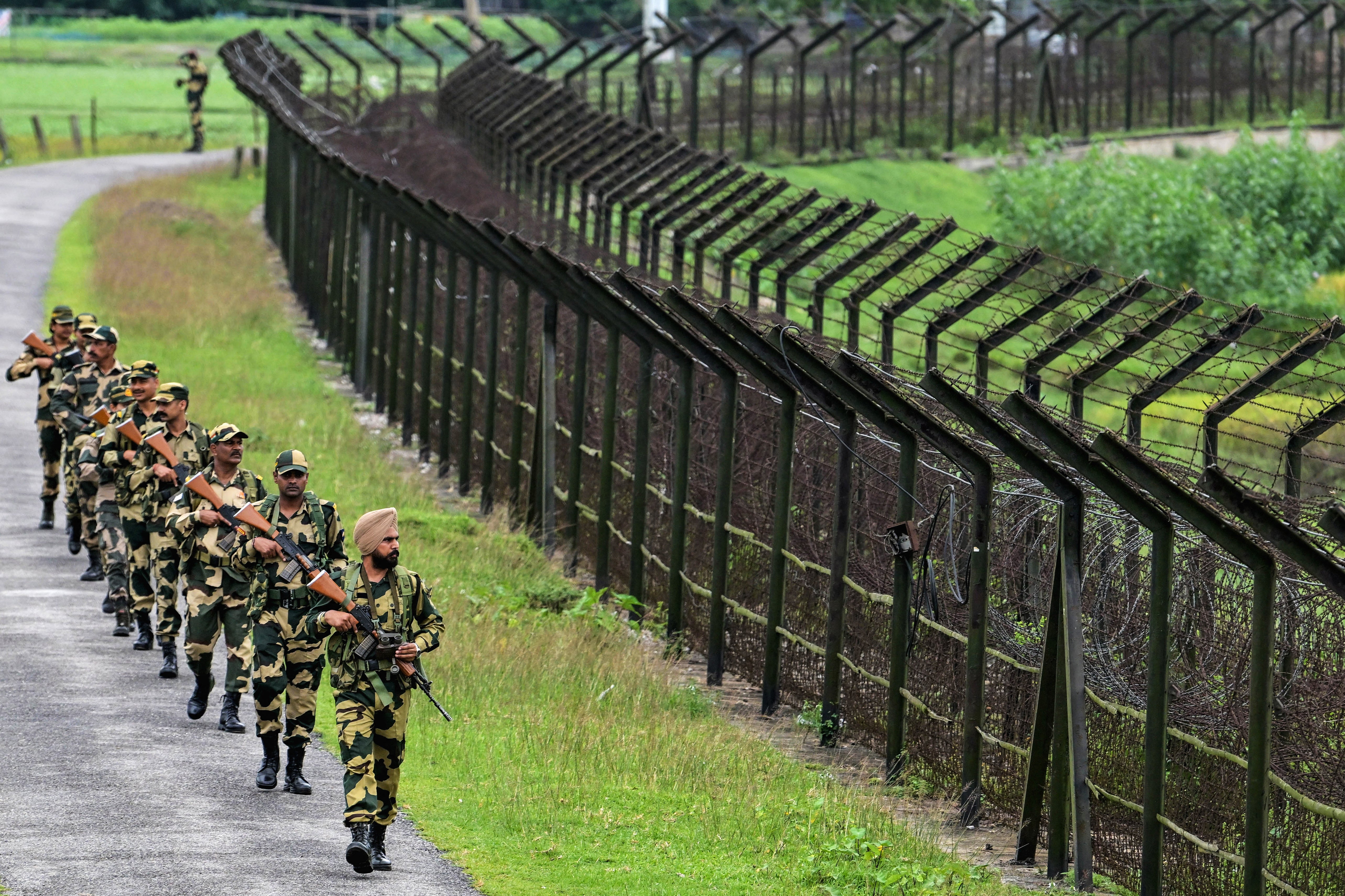 Border Security Force personnel patrol along the border with Bangladesh in Golakganj, Assam
