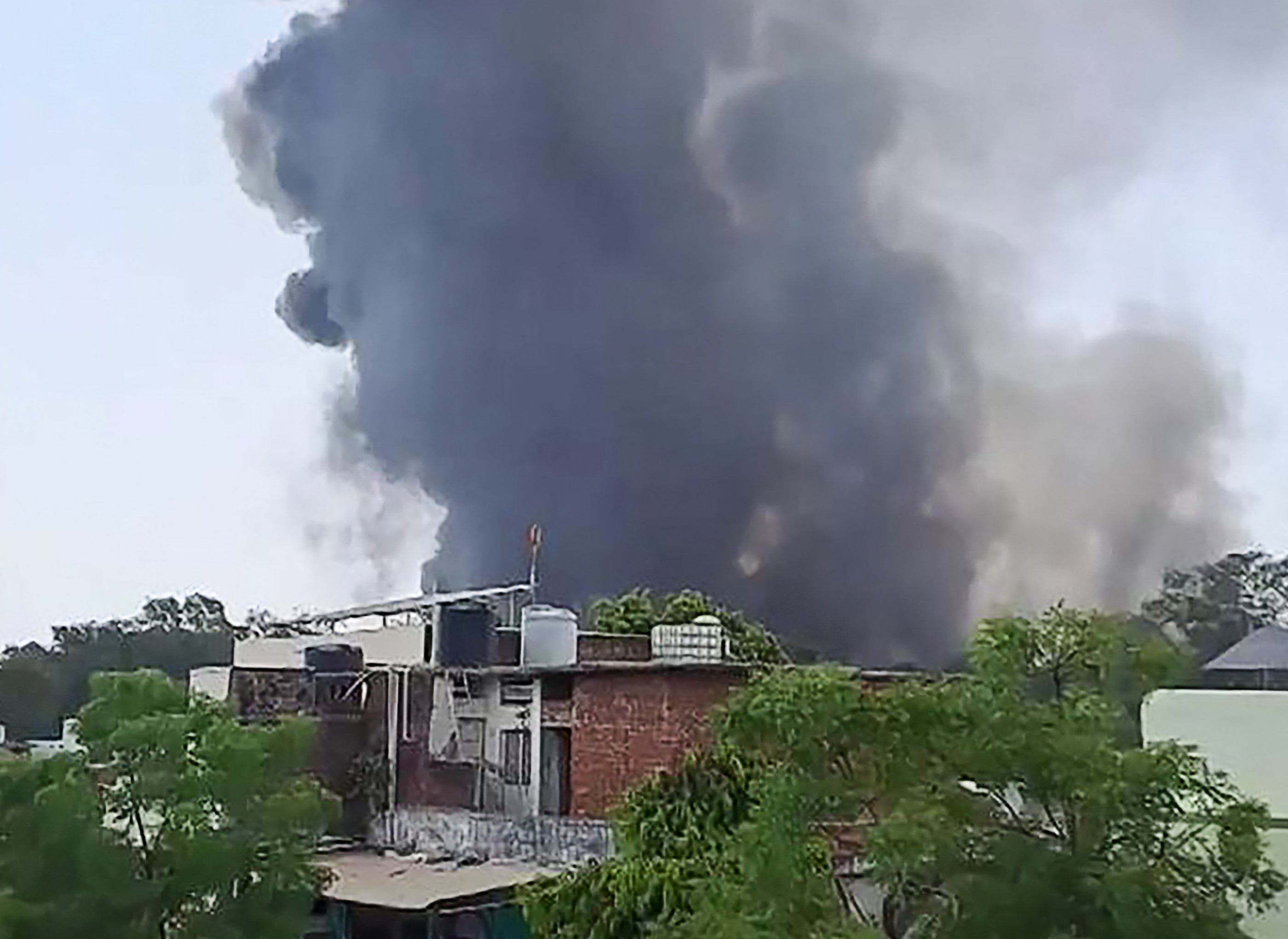 A plume of smoke rising after Air India flight 171 crashed near the airport in Ahmedabad