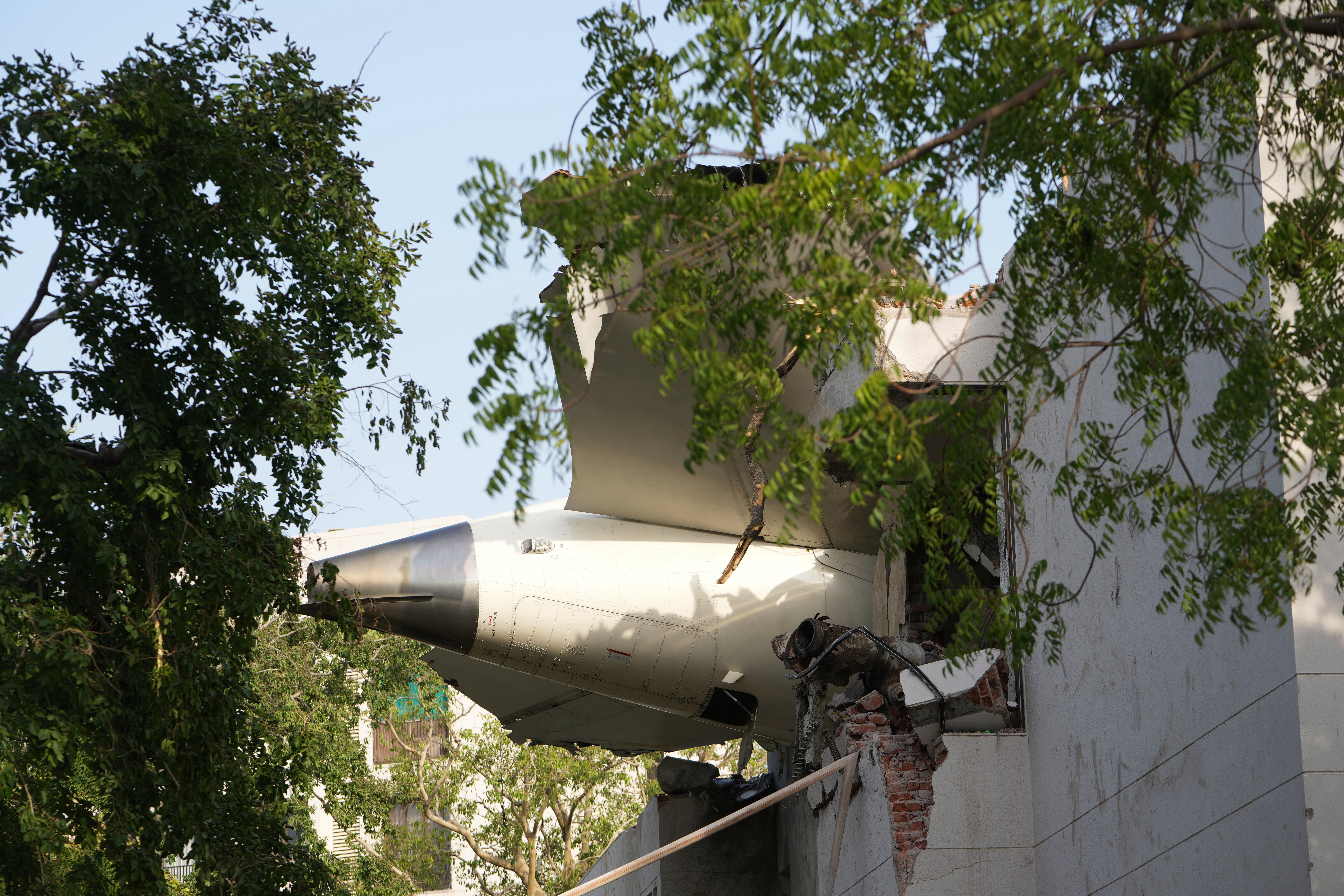 The plane’s tail could be seen protruding from the damaged building after the crash