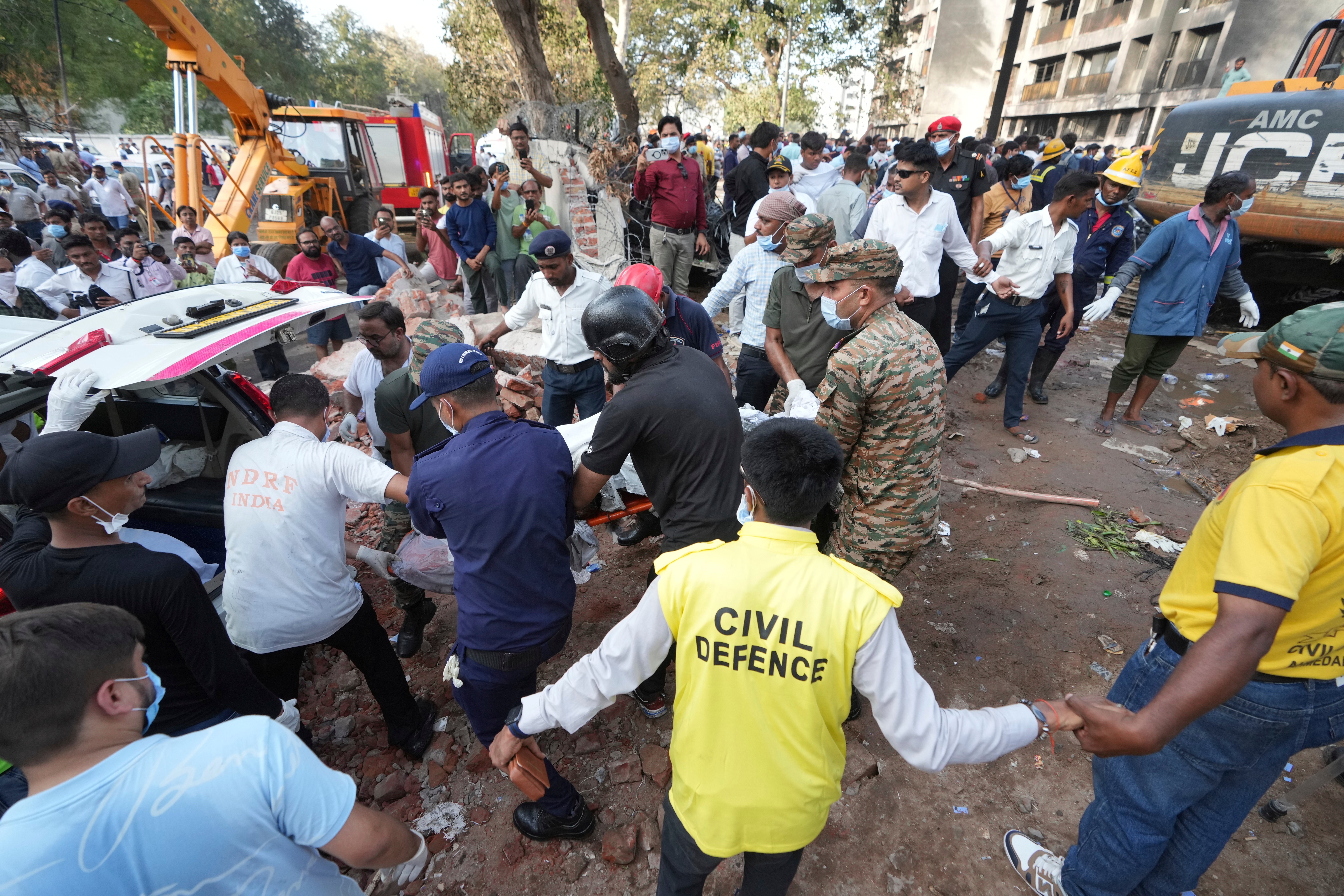 Rescue workers use a stretcher as victims are removed from the site of the plane crash