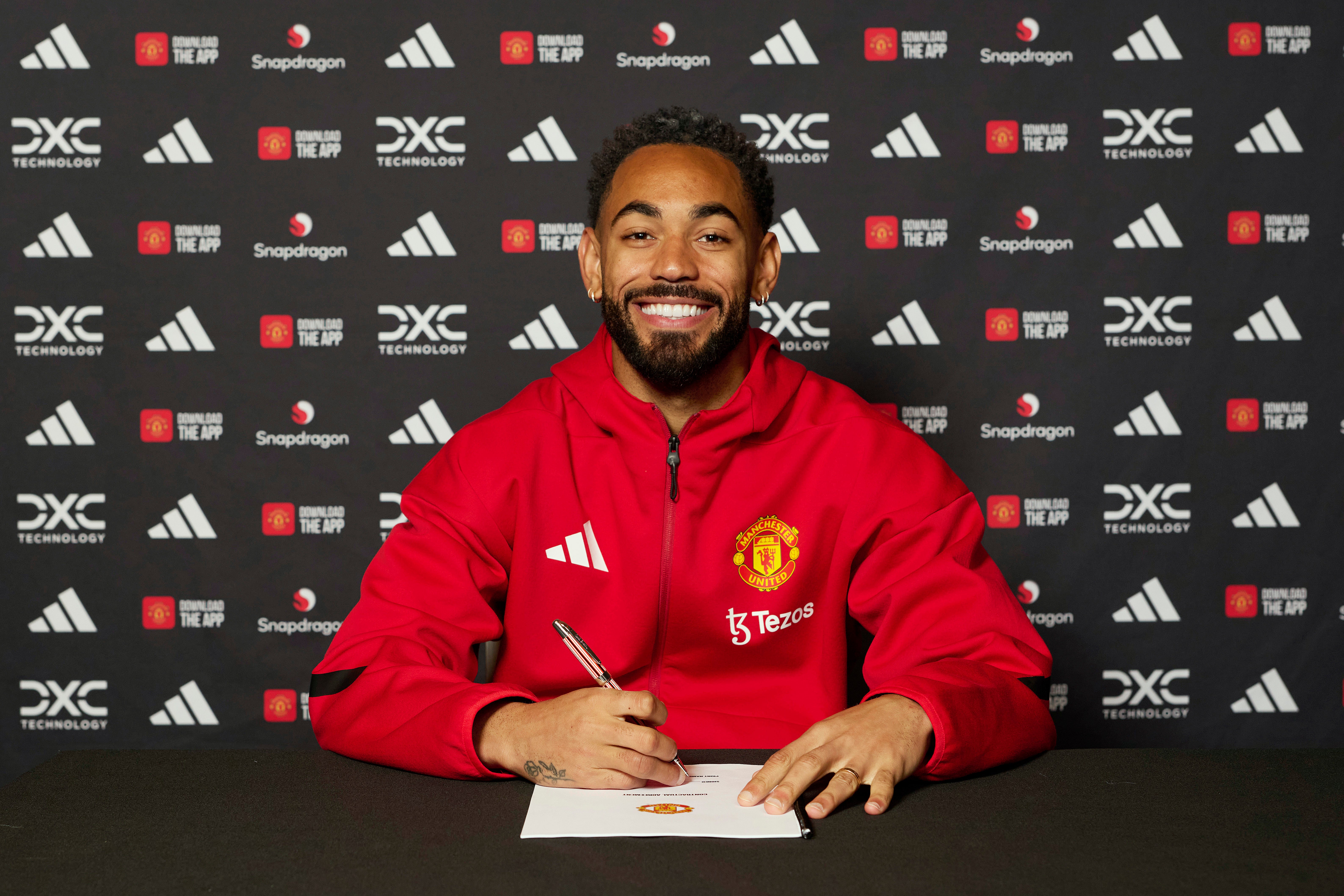 Matheus Cunha of Manchester United signing his contract with the club