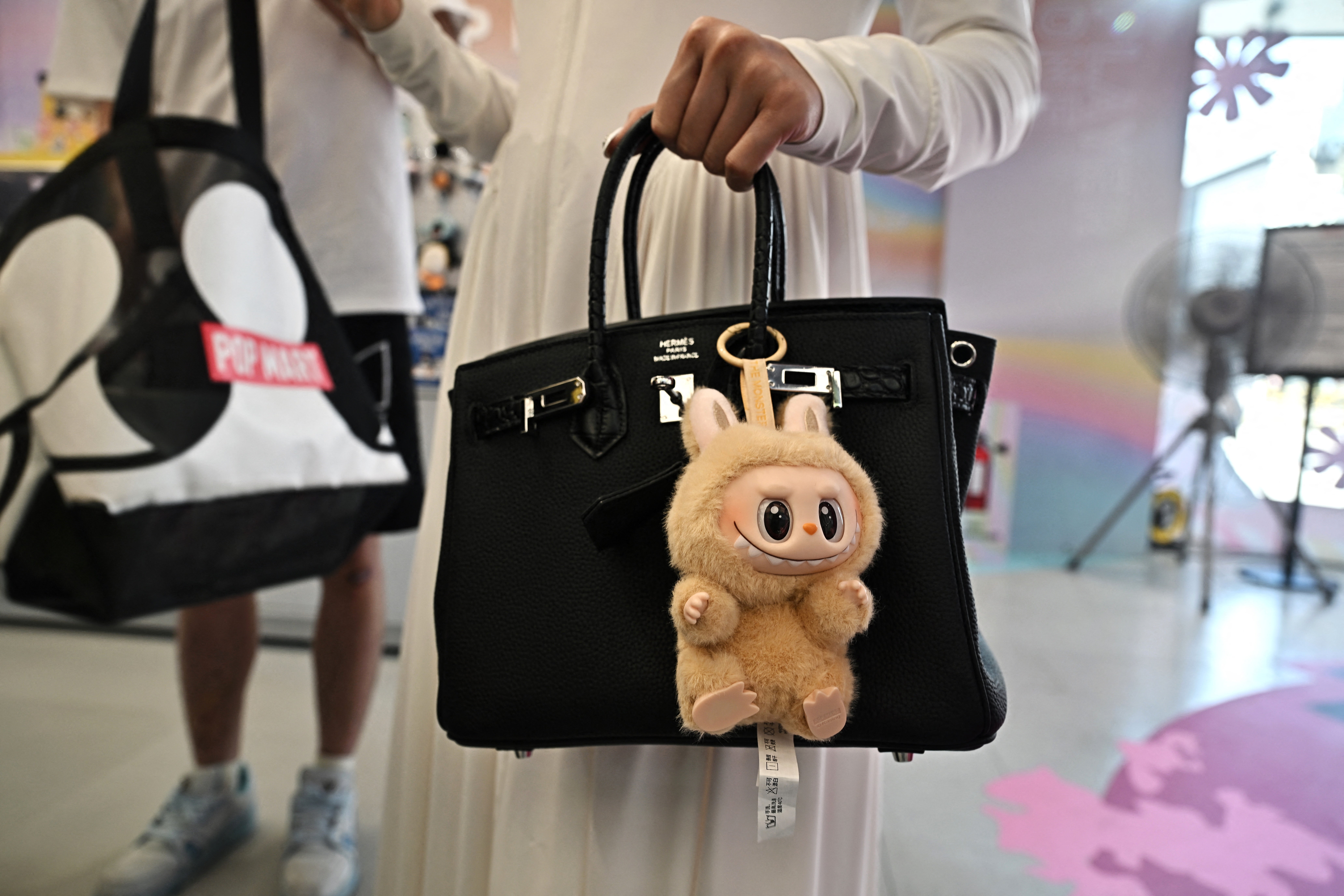 Labubu collectable on a designer bag
