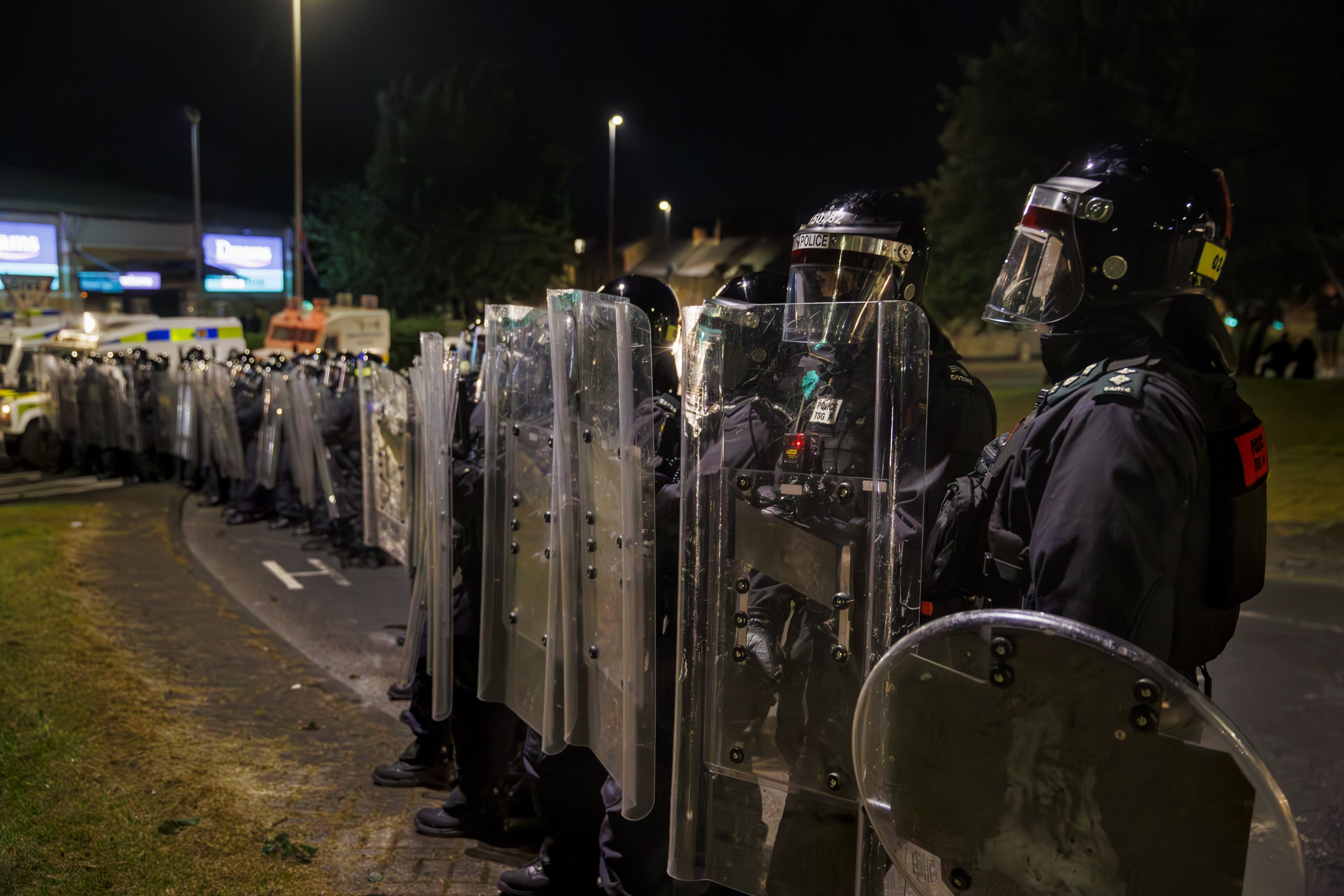 PSNI officers form a barricade with riot shields in Ballymena on Thursday