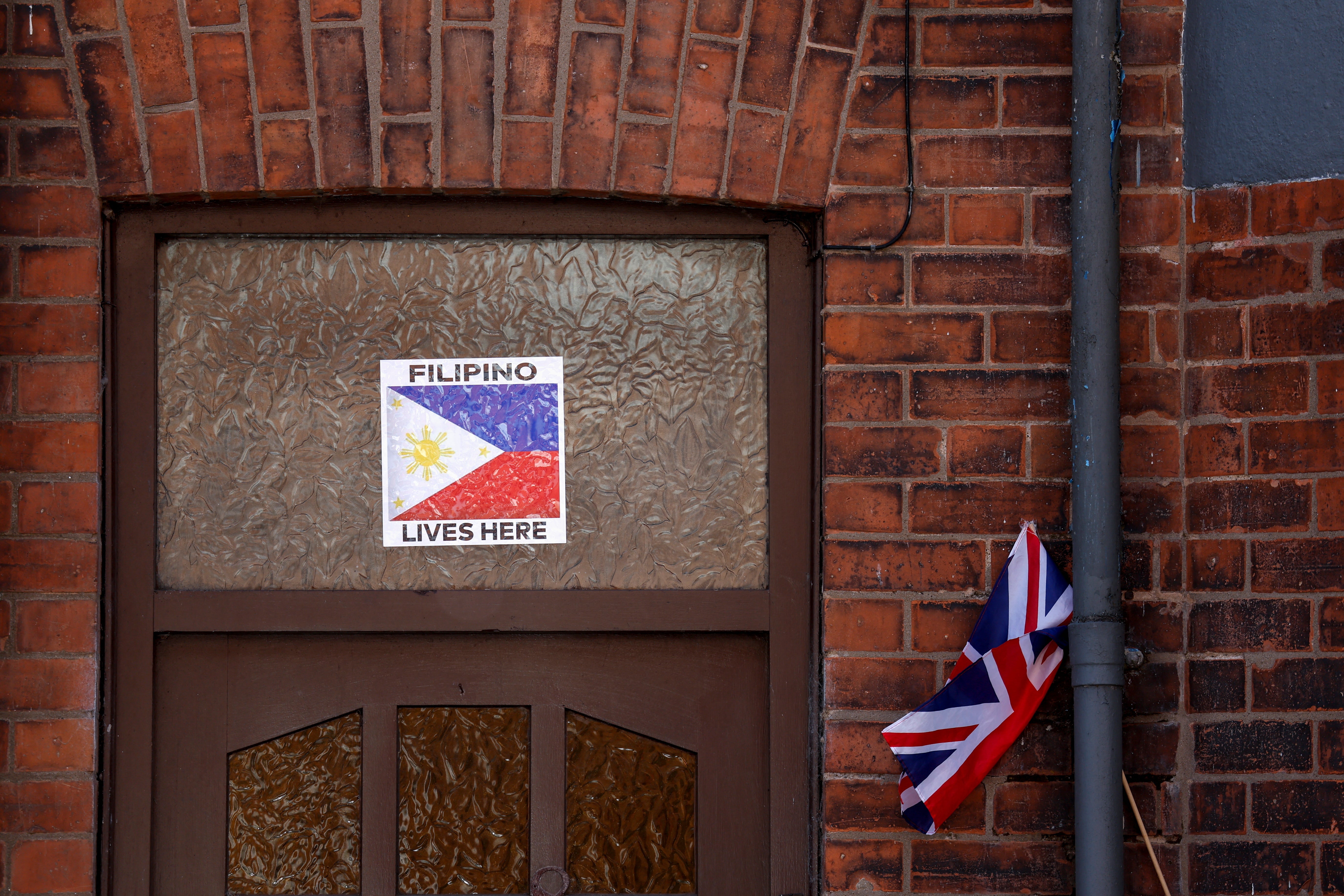 Residents in Ballymena have displayed their nationalities on their doors as clashes continue