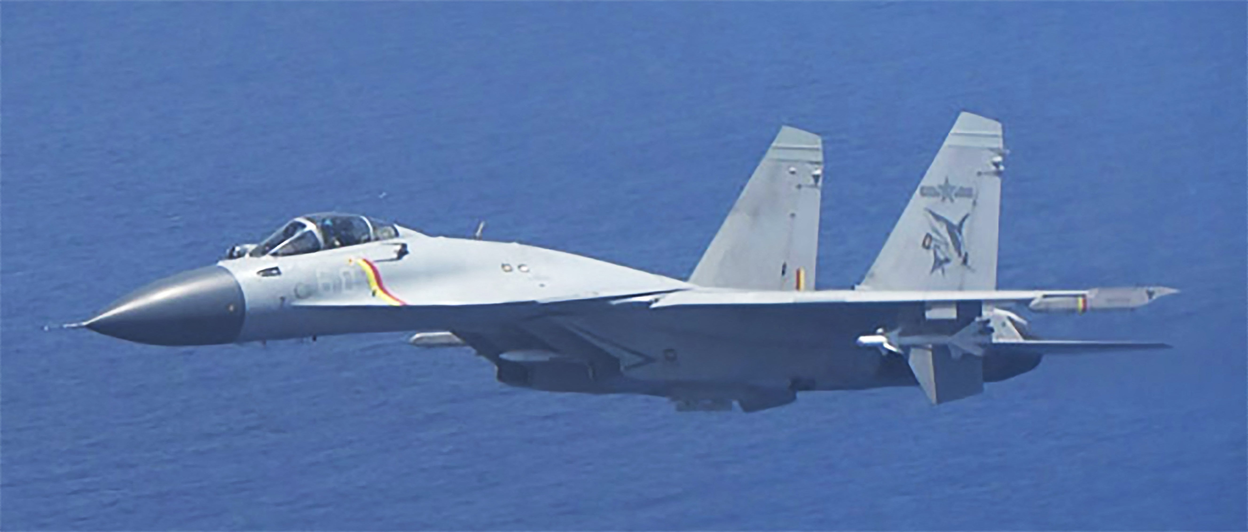 J-15 fighter jet from Chinese aircraft carrier Shandong flies close to a Japanese patrol aircraft conducting surveillance above the Pacific