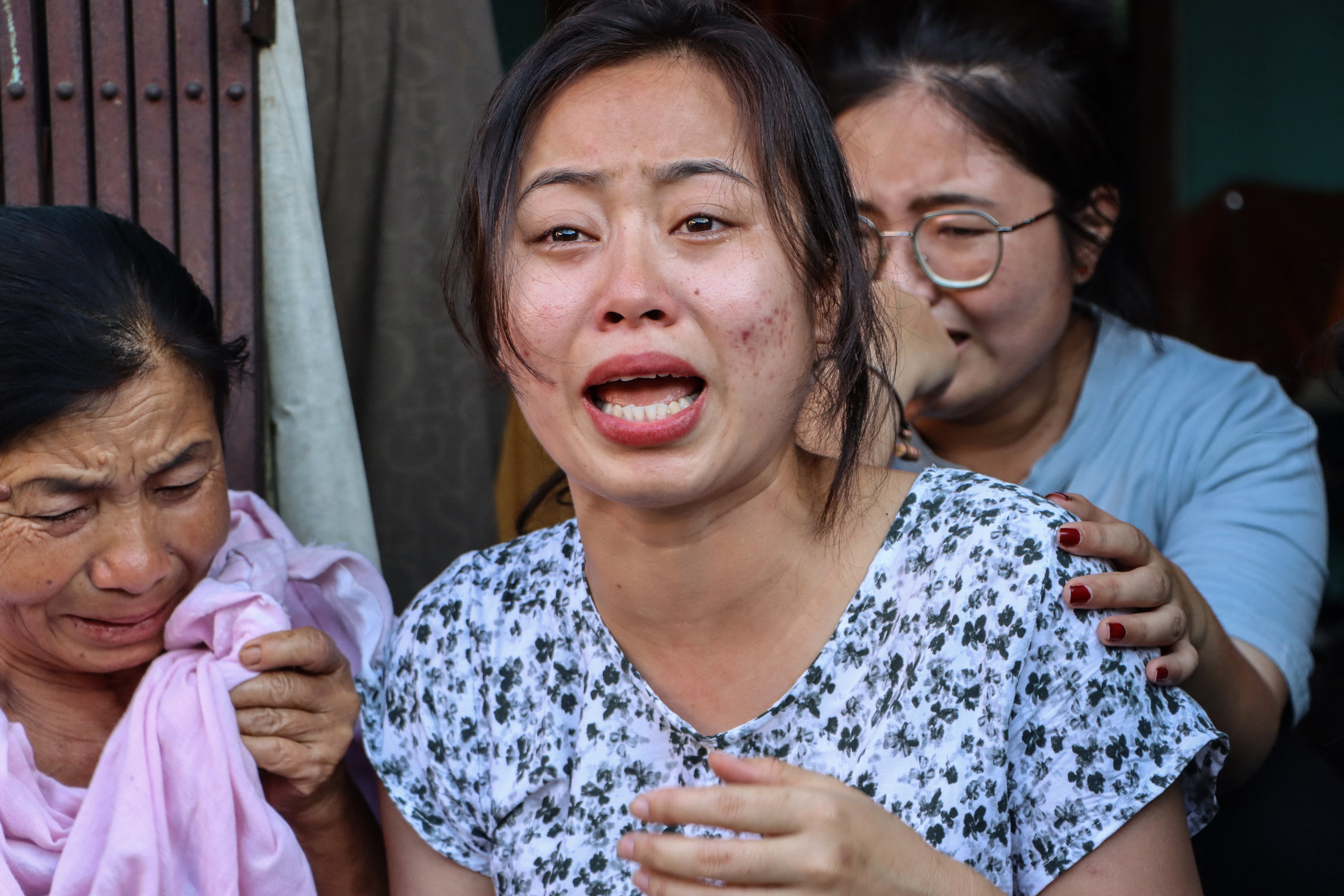 Family members of one AI 171 crew members mourn at their home in Thoubal Mayai Leikai in the northeastern Indian state of Manipur