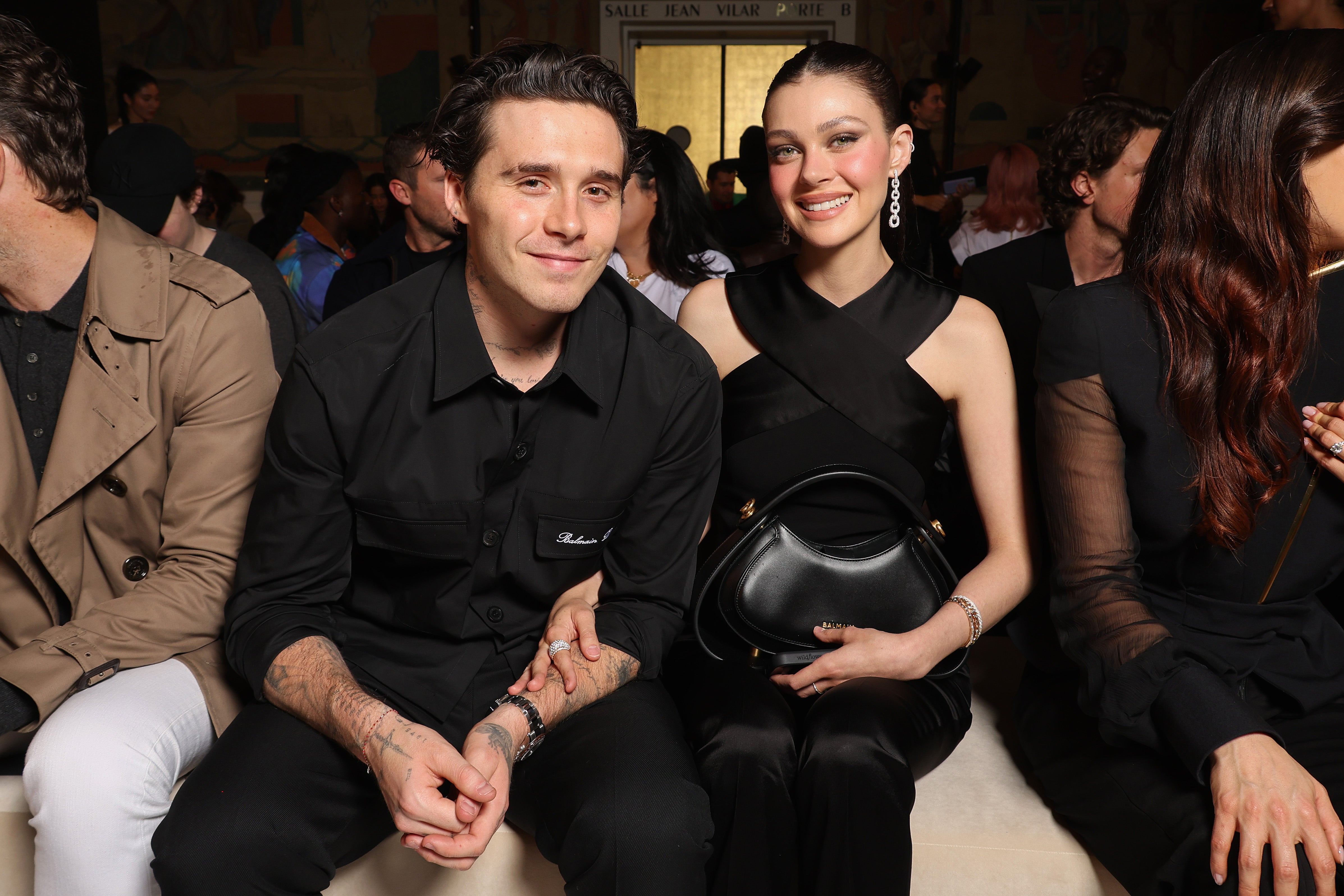 Brooklyn Beckham and Nicola Peltz attend the Balmain SS2025 show