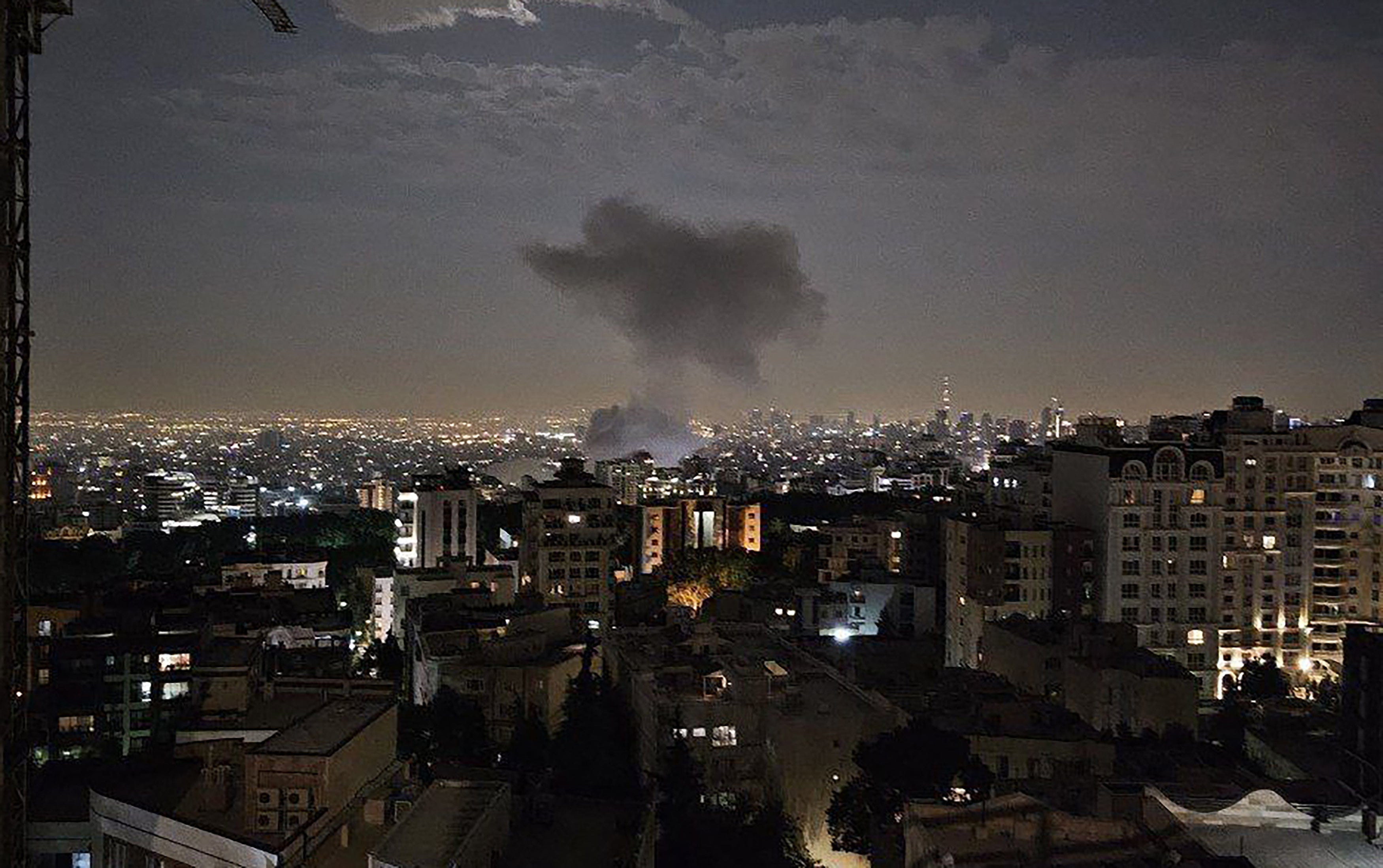 Smoke billowing from a site reportedly targeted by an Israeli airstrike on the Iranian capital Tehran in the early hours of Friday morning