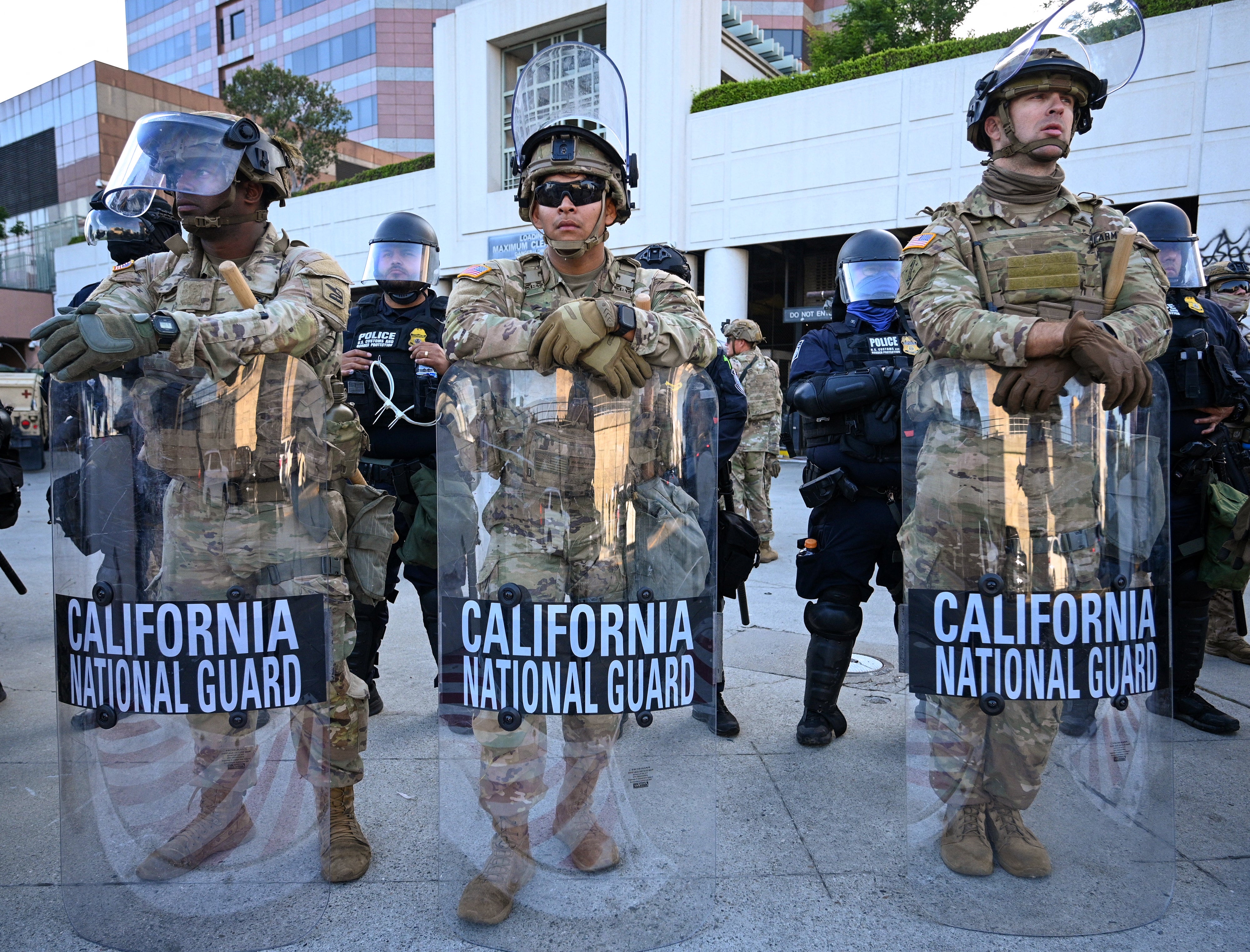 Members of the California National Guard stand guard at the loading dock of the Roybal Federal Building in downtown Los Angeles on Thursday