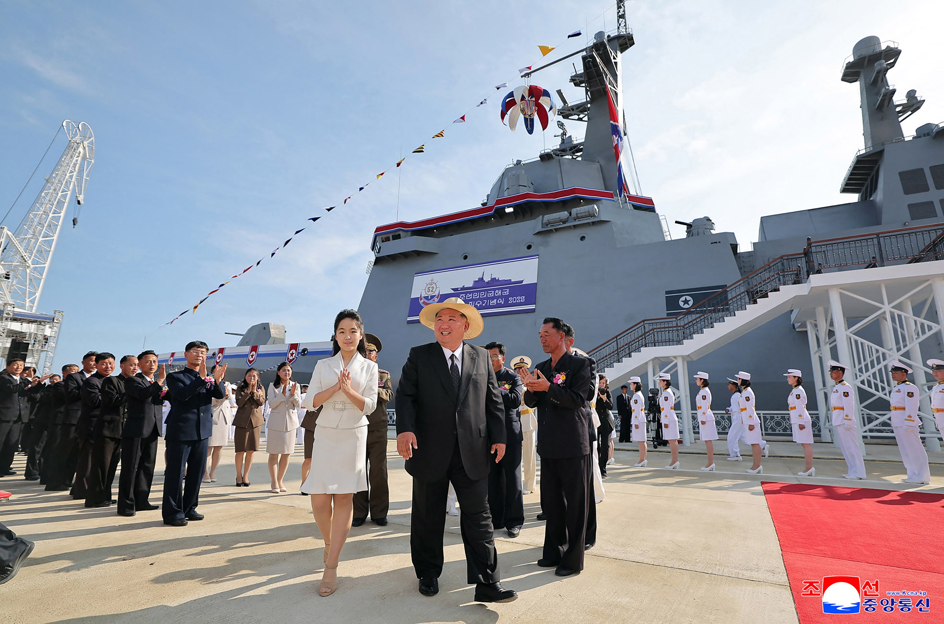 North Korea's leader Kim Jong Un (C) and his daughter Ju Ae (centre L) attending the launch ceremony for the 'Kang Kon' at the Rajin shipyard at the port near Rason