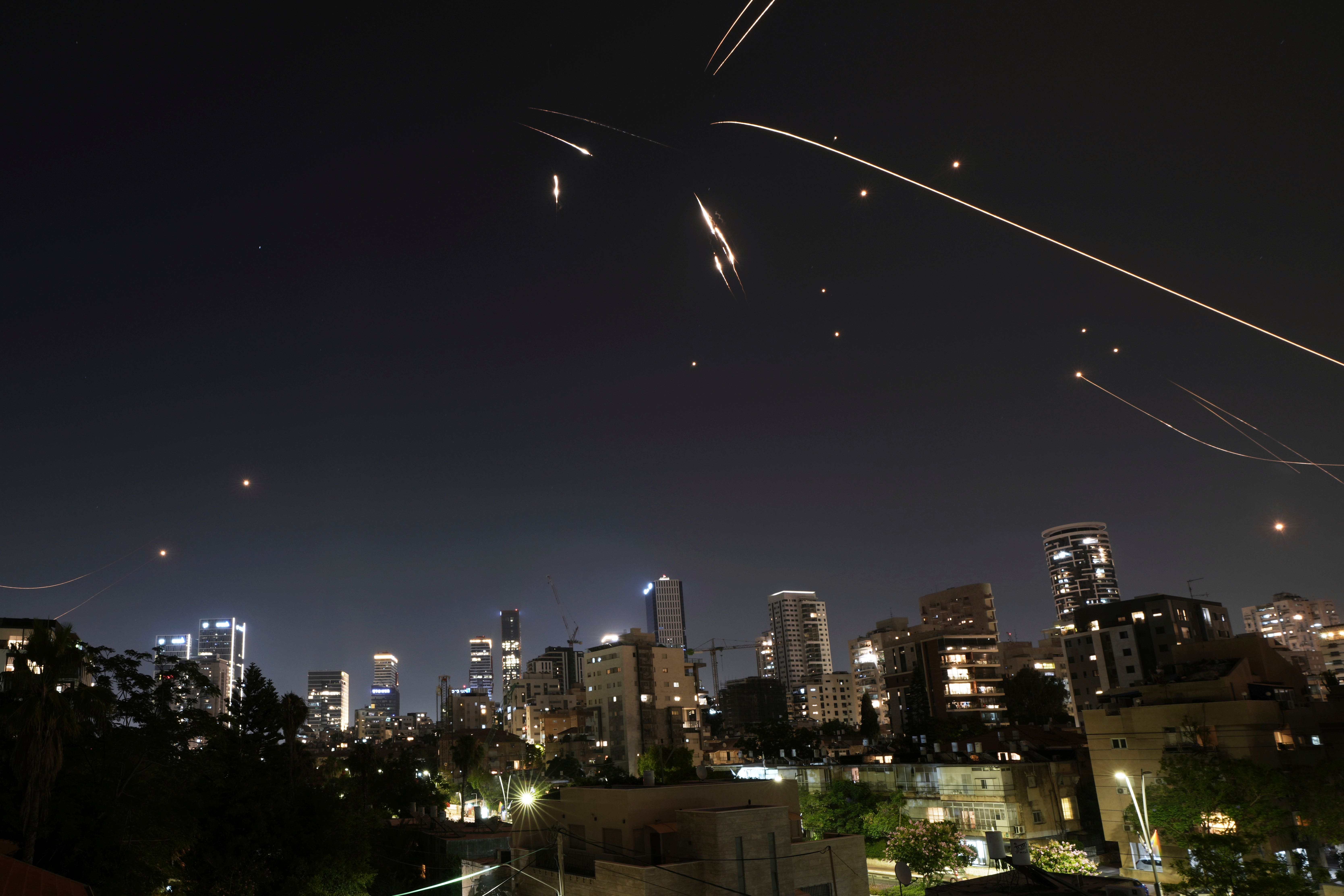 Israel’s air defence system fires to intercepts projectiles launched from Iran, as seen in Ramat Gan, near Tel Aviv on Friday (Oded Balilty/AP)