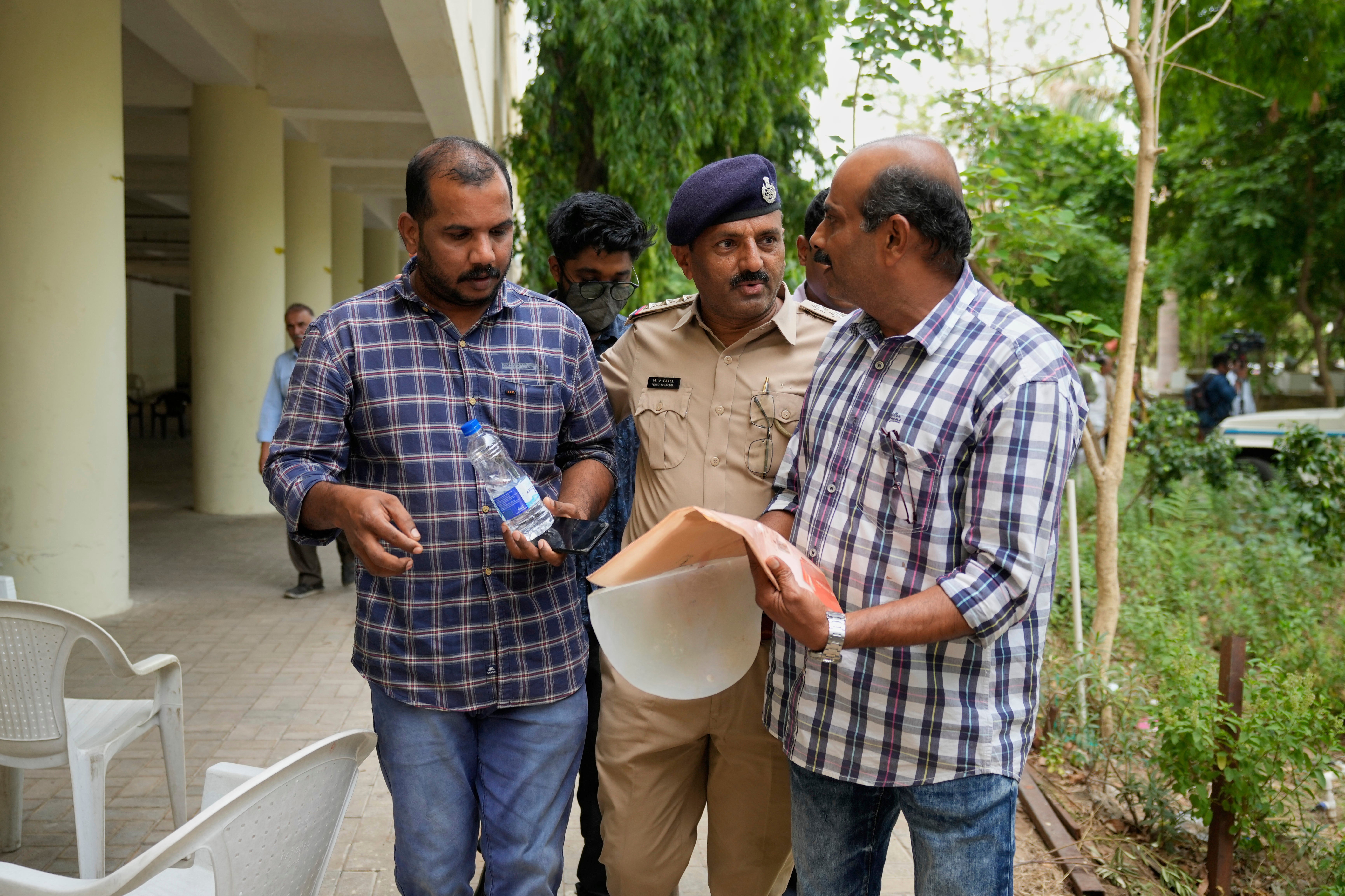Ratheesh Nair, left, brother of Air India plane crash victim Ranjitha Nair, leaves a hospital after giving his DNA sample to identify his sister’s body in Ahmedabad, Saturday 14 June 2025