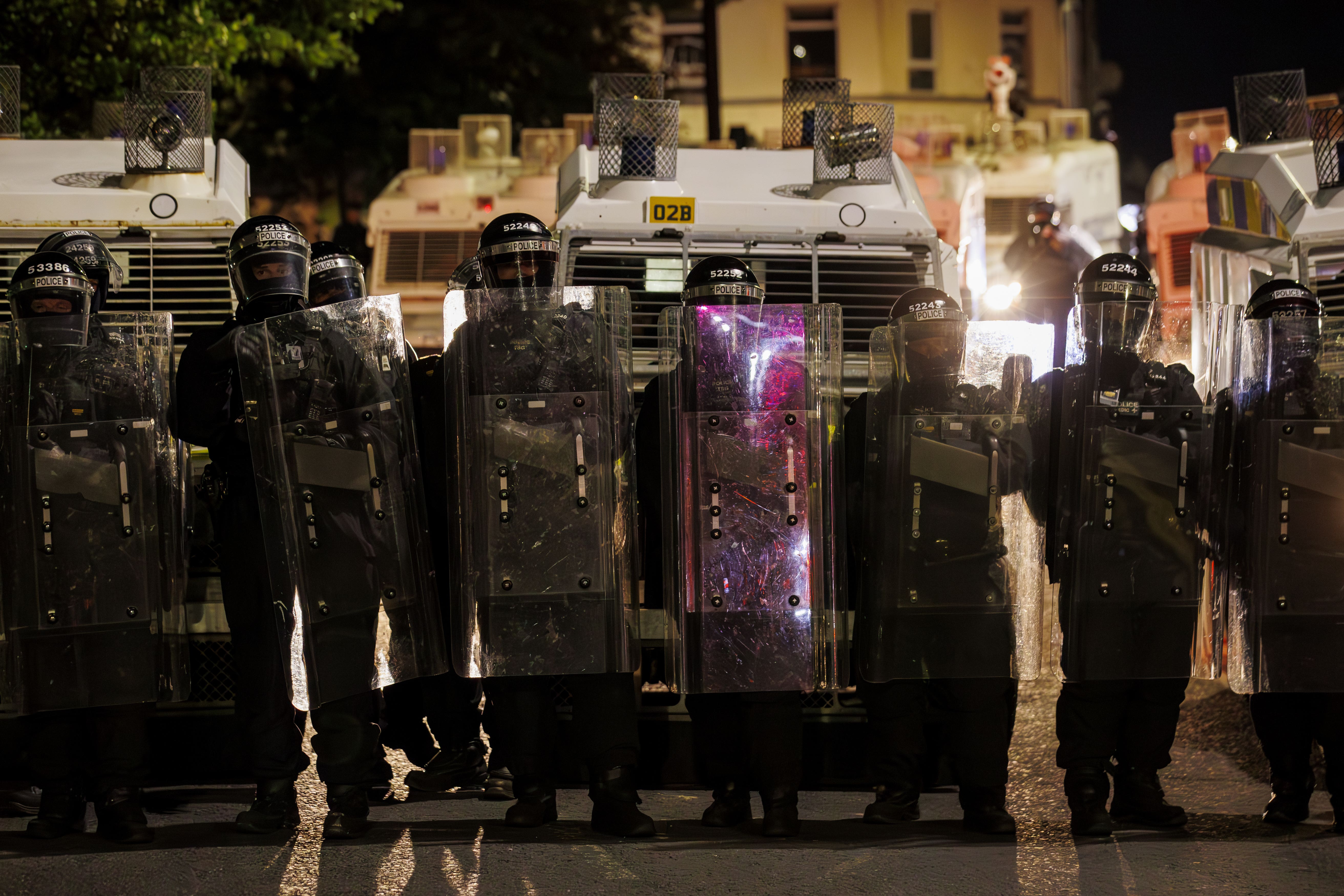 Officers from the PSNI form a barricade with riot shields during disorder in Ballymena this week (Liam McBurney/PA)