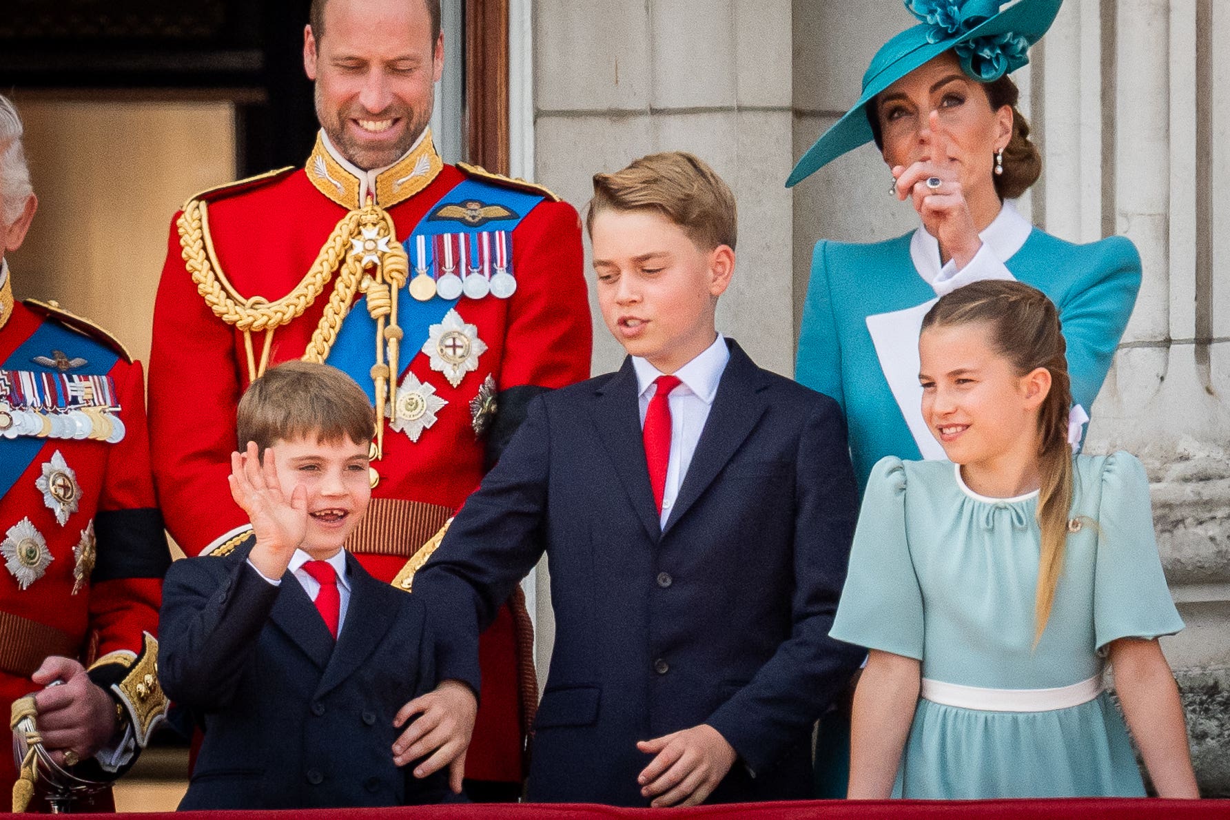 Prince George puts a calming hand on Prince Louis as he waves during a flypast during the Trooping the Colour (Aaron Chown/PA)