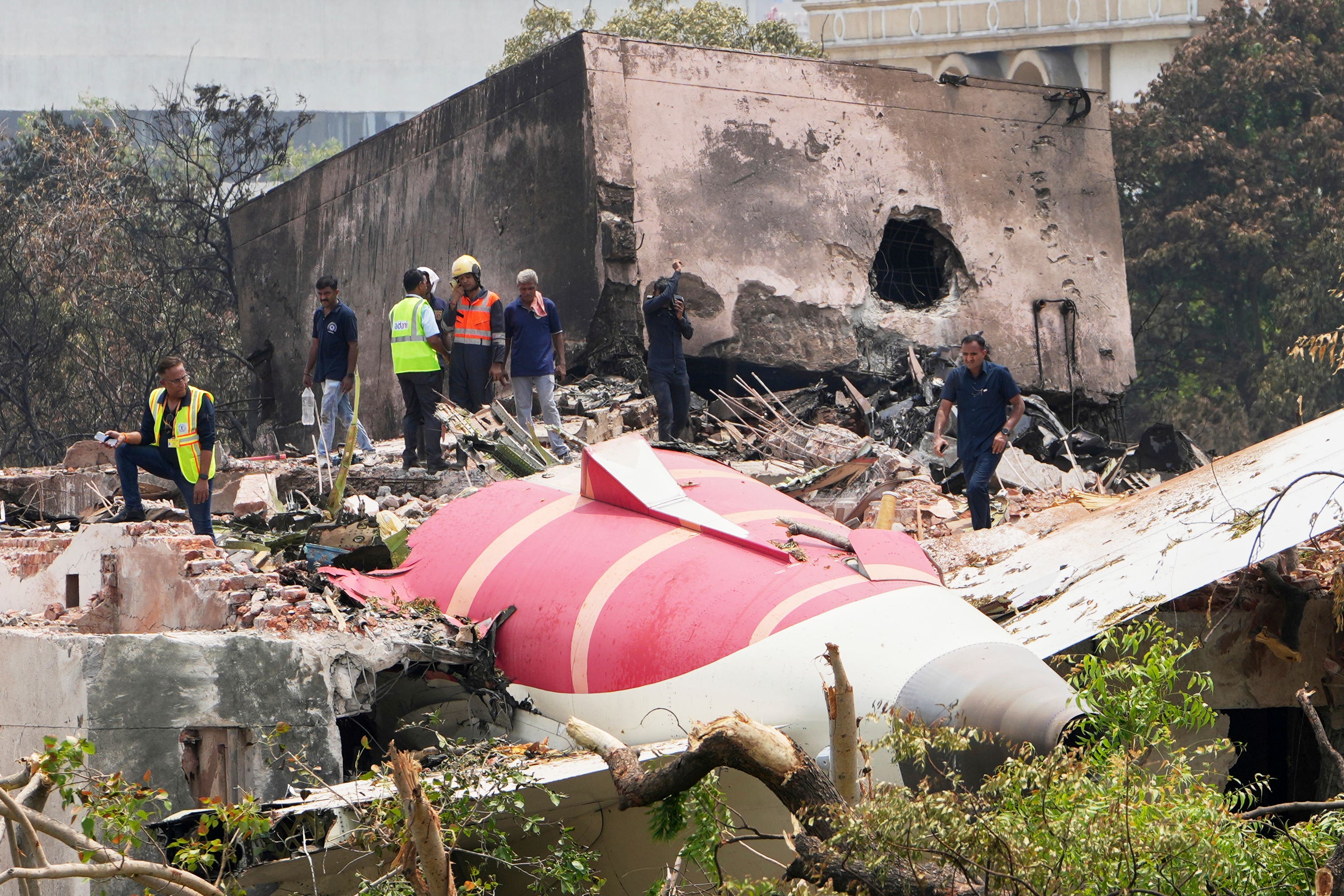 Officials inspect the site of Thursday’s Air India plane crash (Ajit Solanki/AP)