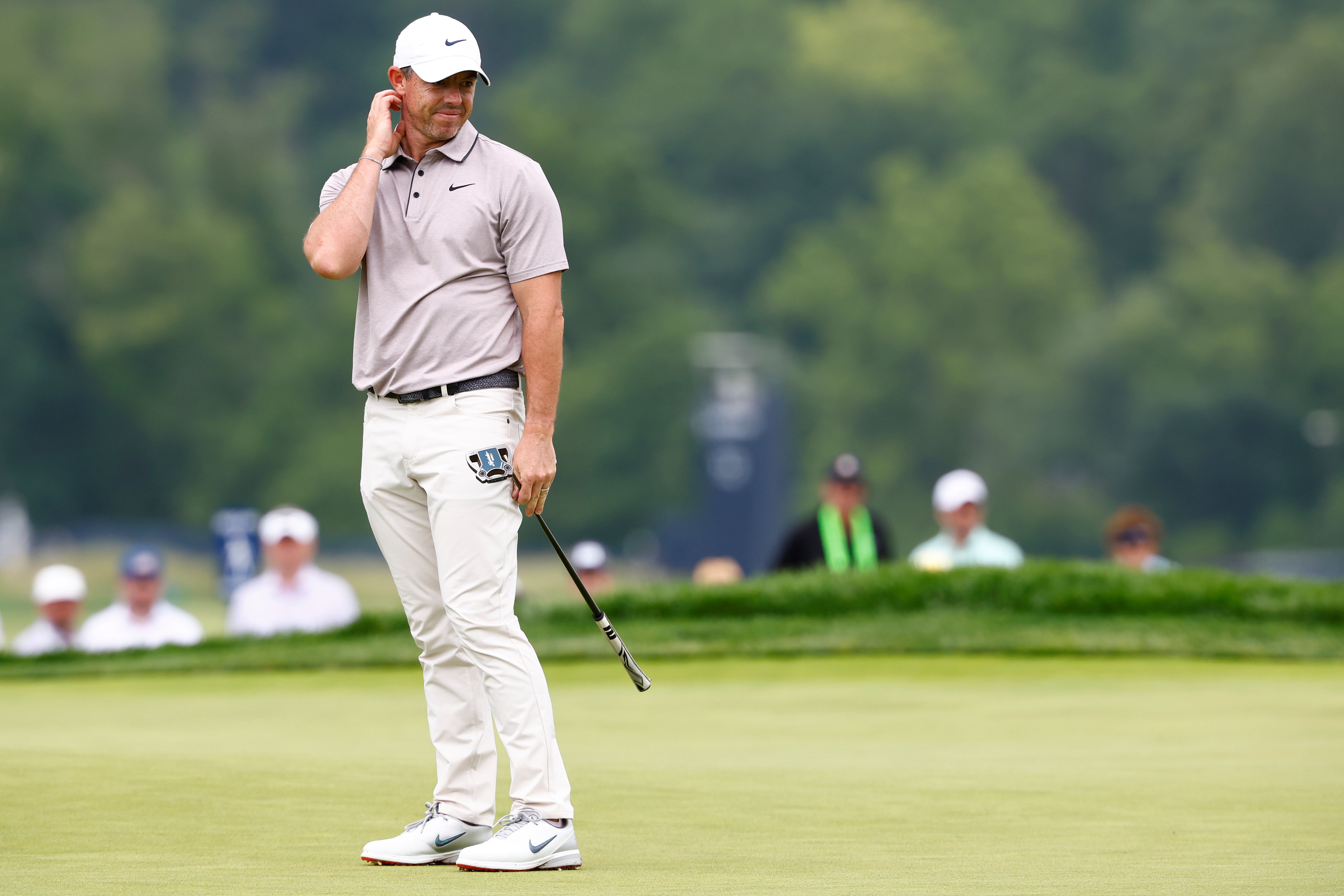 Rory McIlroy of Northern Ireland reacts after putting from the 9th hole