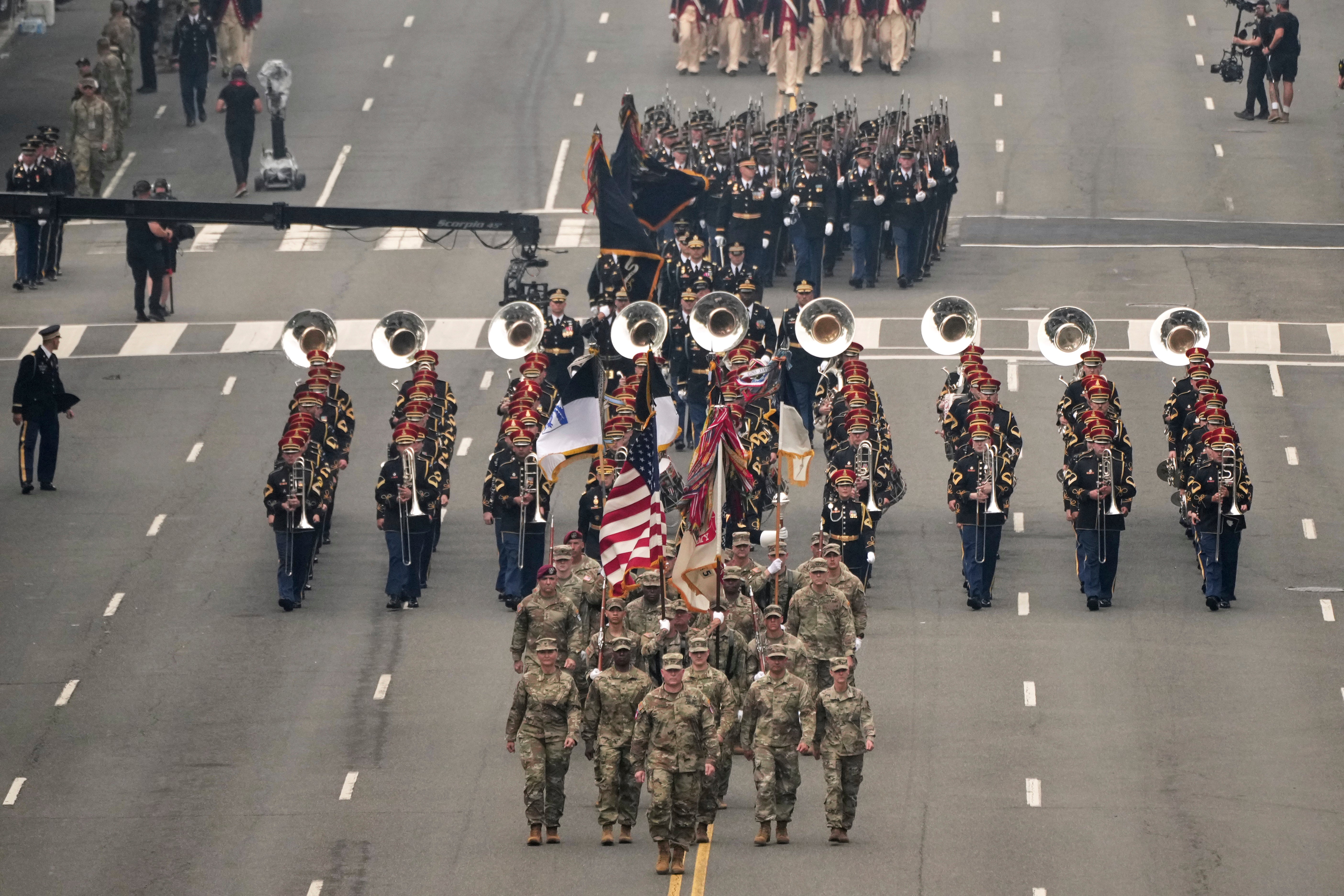 Marching band and Army soldiers walk in downtown Washington DC