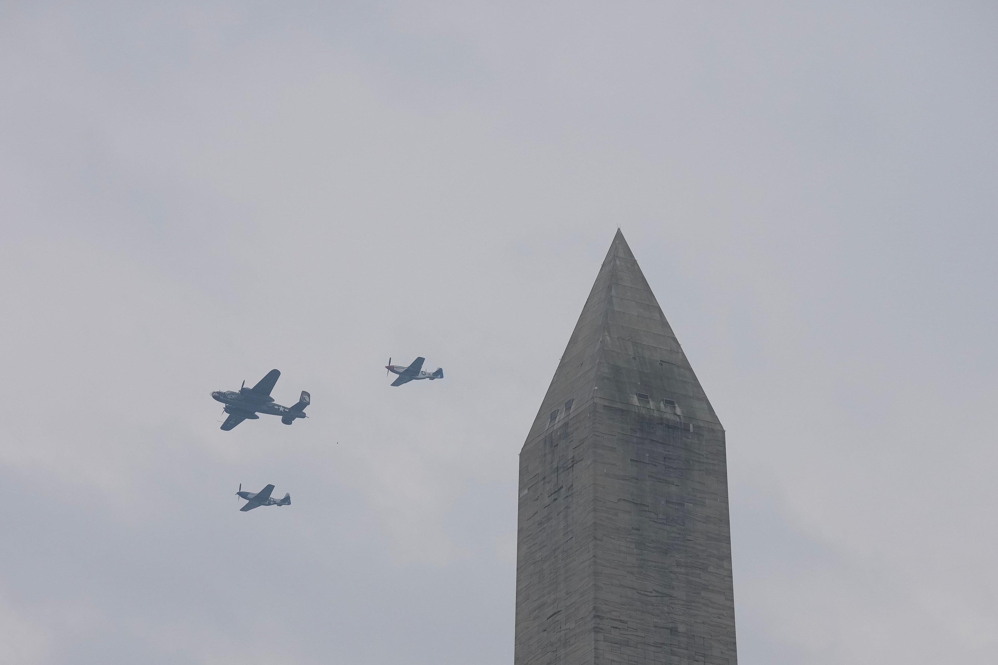 A U.S. Army B-25 and two P-51's fly past the Washington Monument