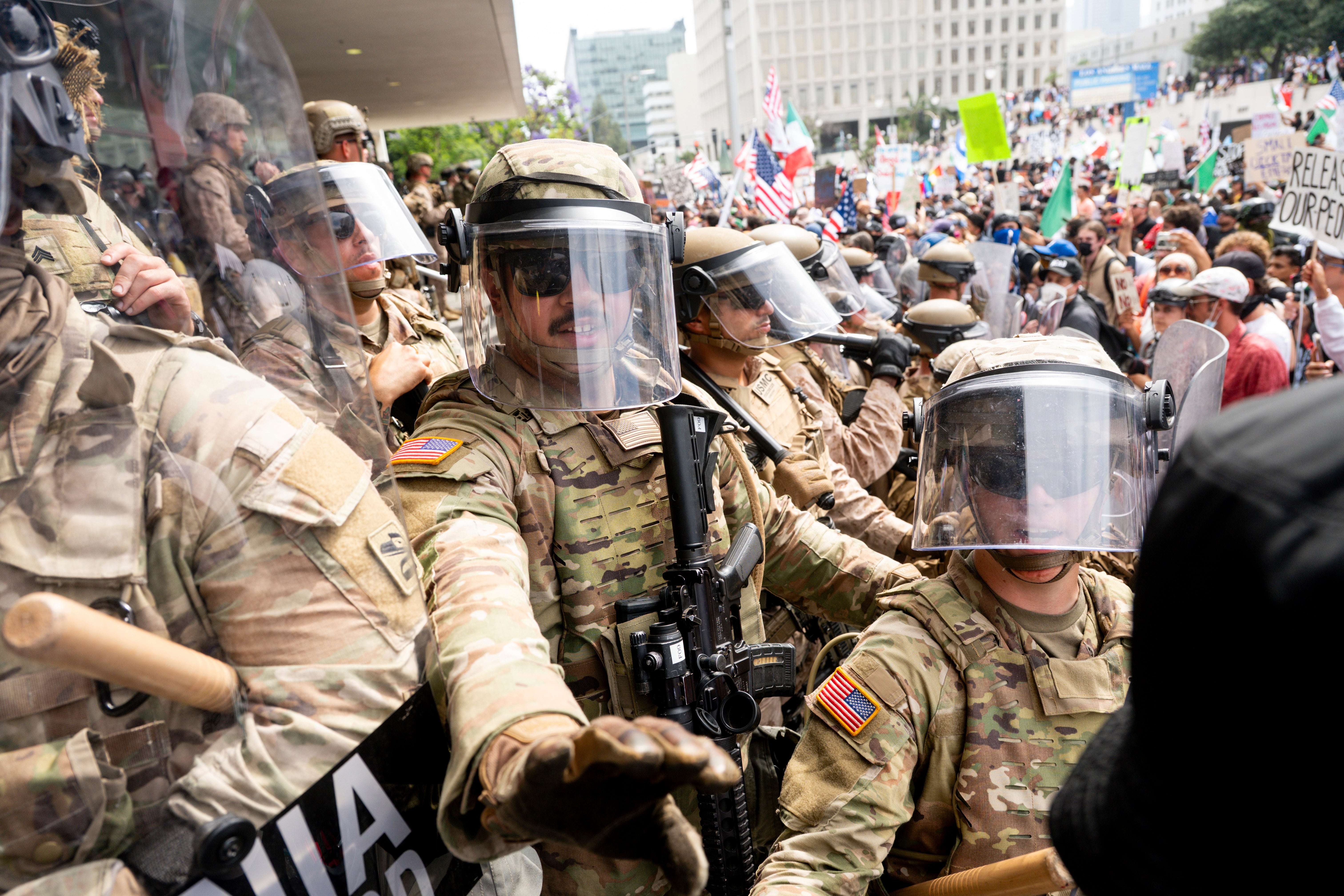 California National Guard and Marines hold back demonstrators at the Federal Building during a protest Saturday in Los Angeles