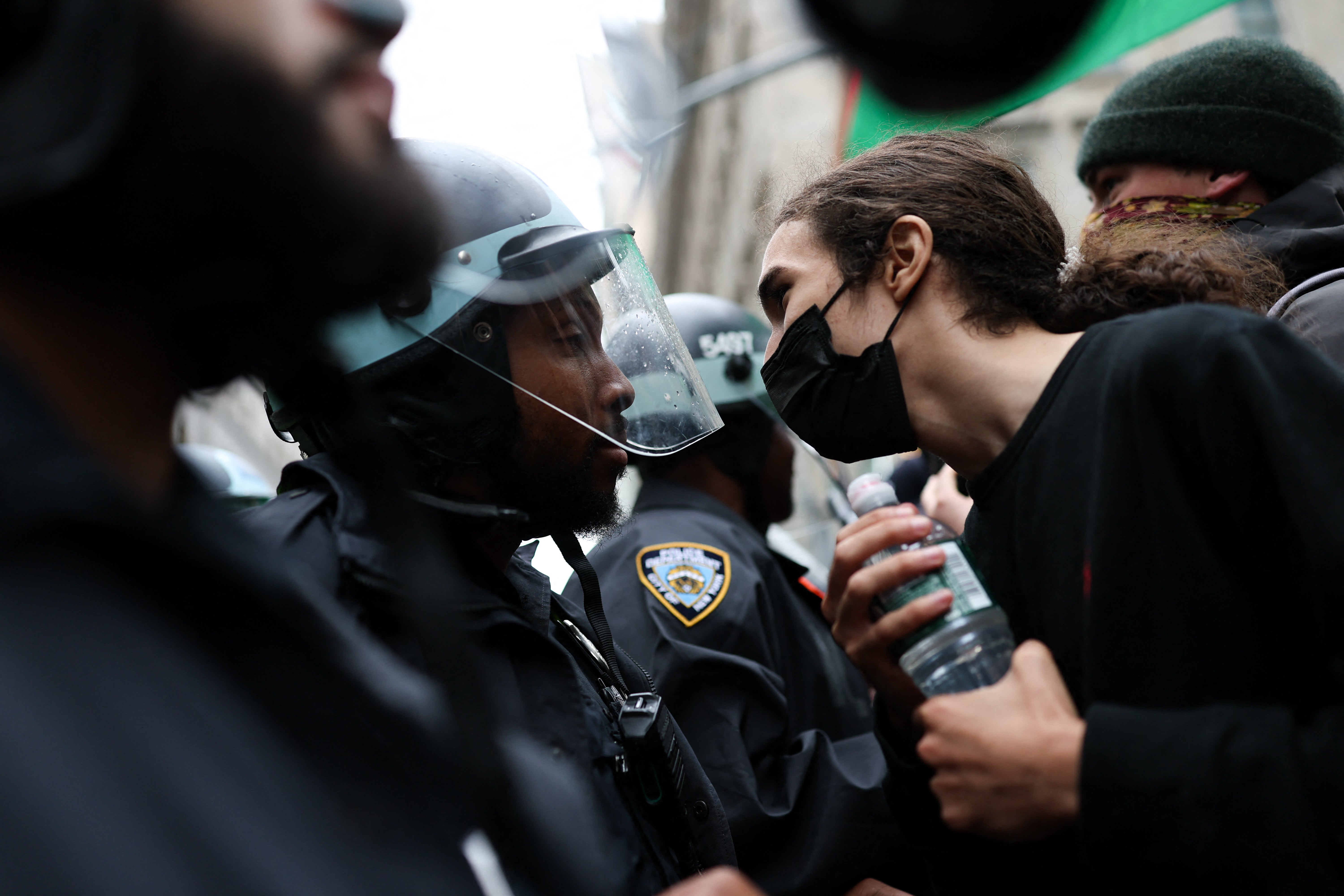 Protests were largely peaceful with few arrests nationwide and rallies were winding down by late afternoon. Pictured: A protestor confronts police in New York City