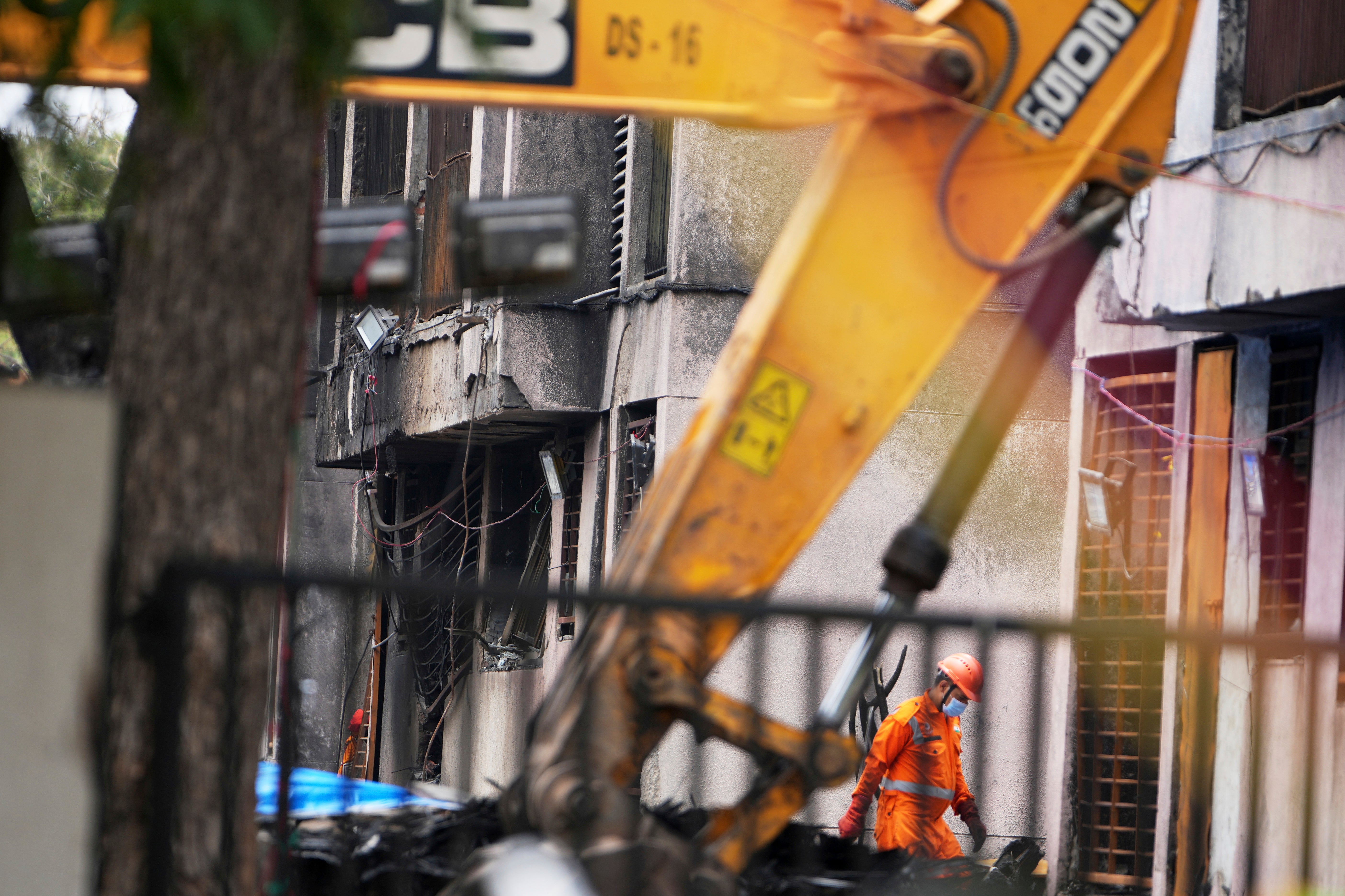 A member of the National Disaster Response Force is seen at the crash site